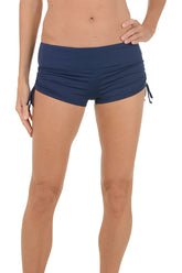A woman wearing a navy swim boxer.