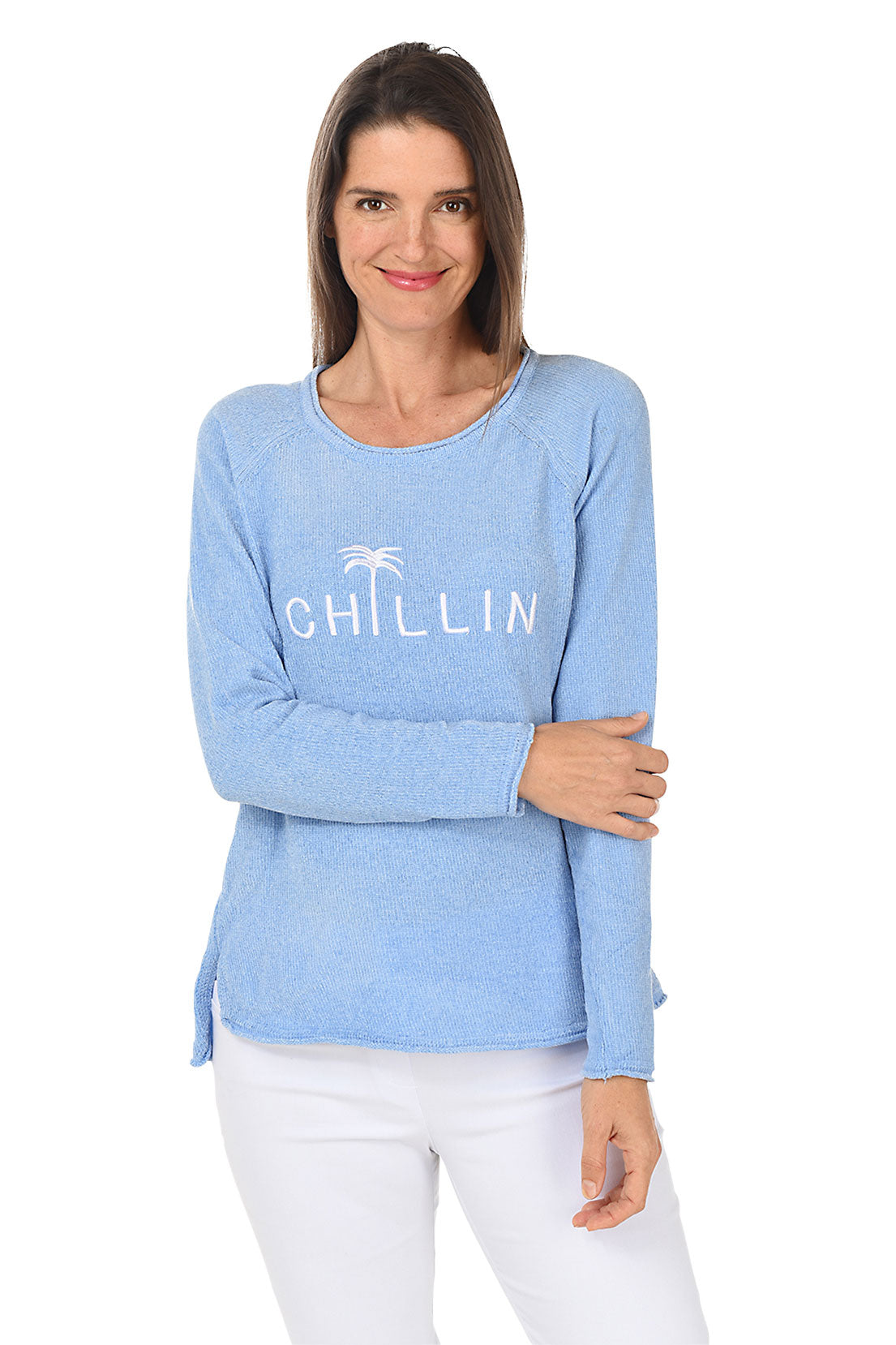 A woman wearing a chenille periwinkle sweater with the words "Chillin" across the chest.