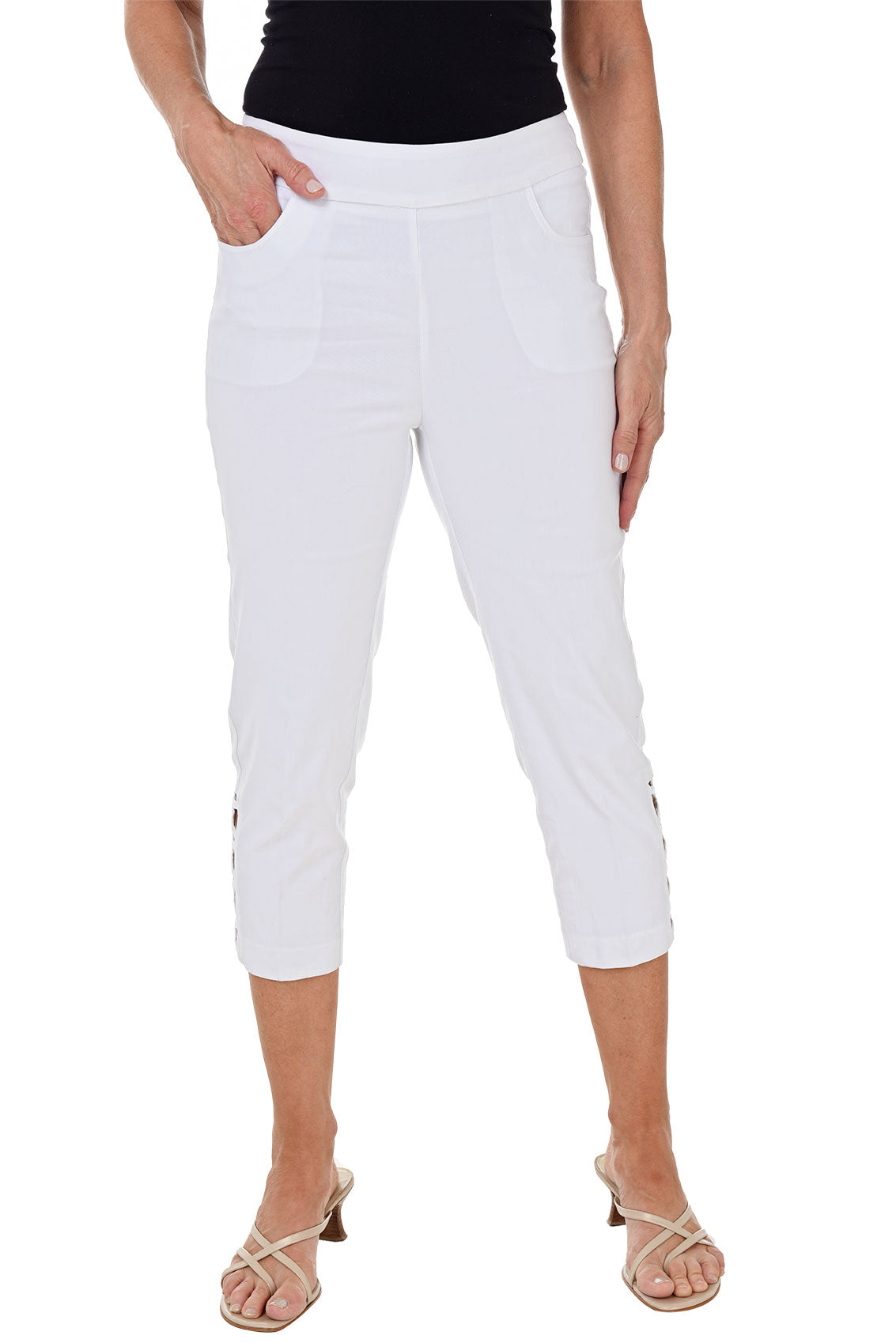 White capri pants worn by a person on a white background