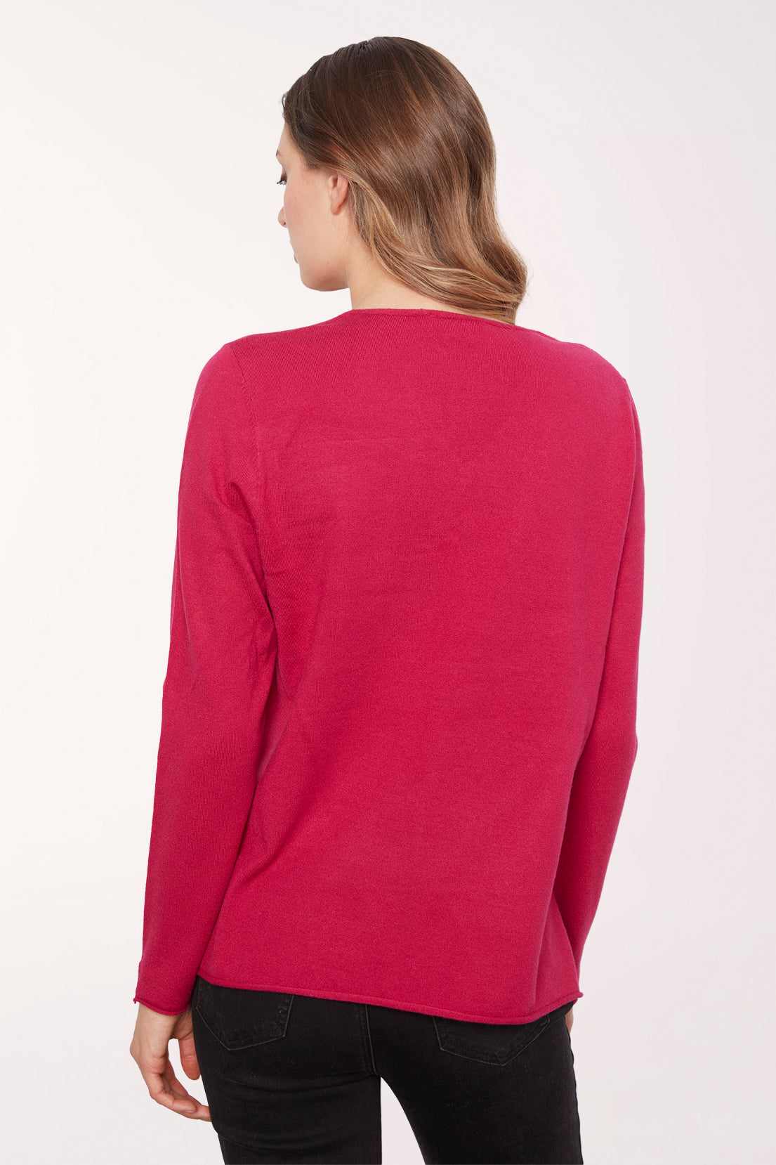 Woman wearing a solid red v-neck long sleeve sweater