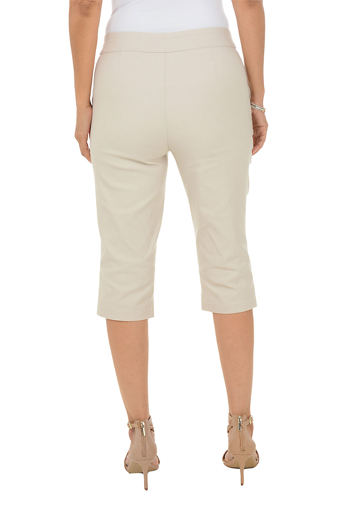 Beige capri pants worn by a person on a white background. Back shot.