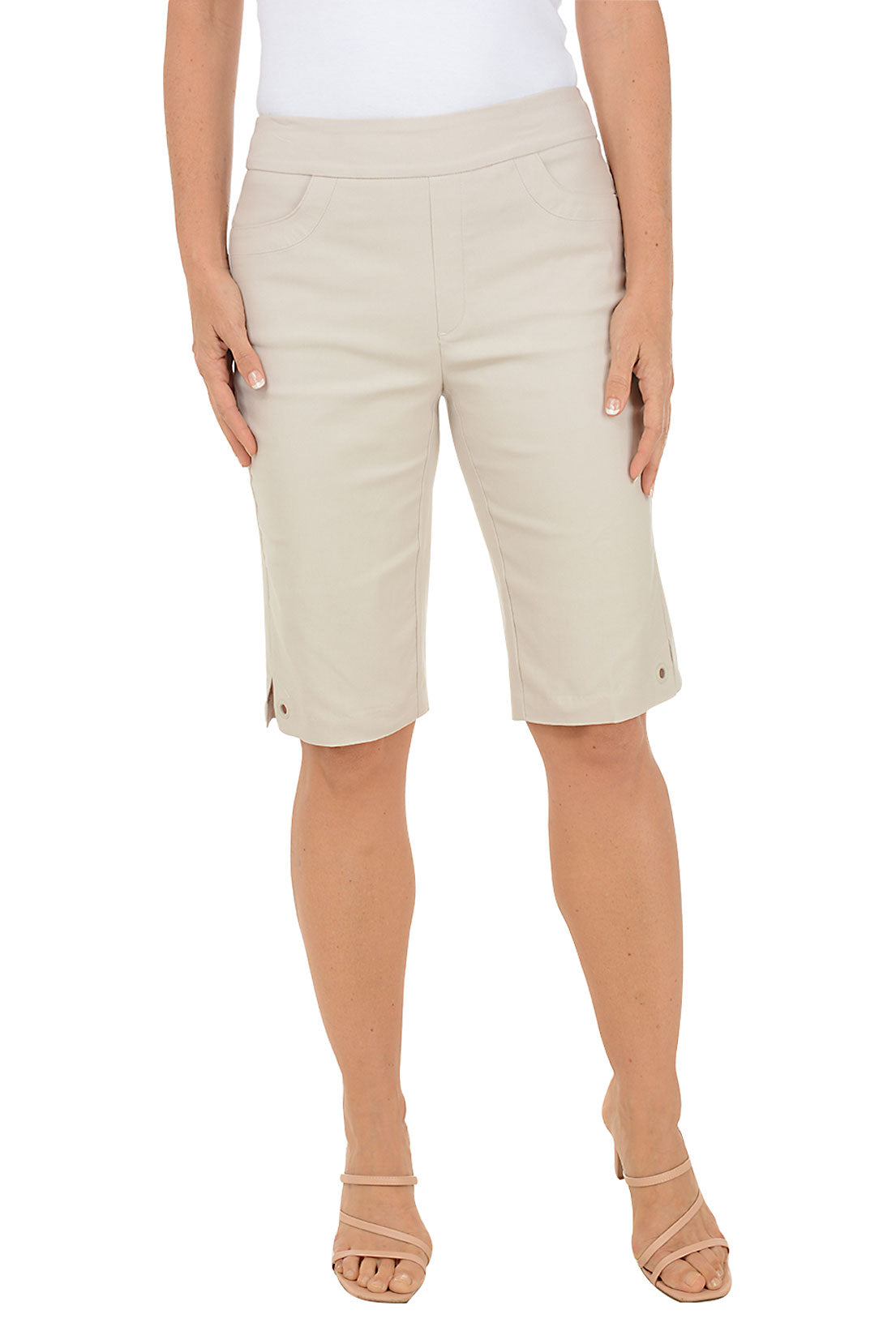 Beige shorts worn by a person on a white background