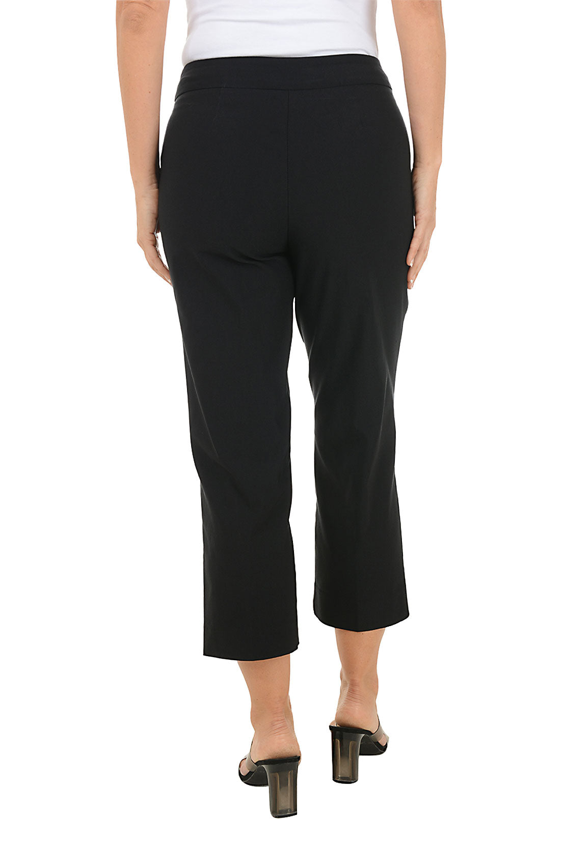 Black crop pants worn by a person on a white background. Back shot.