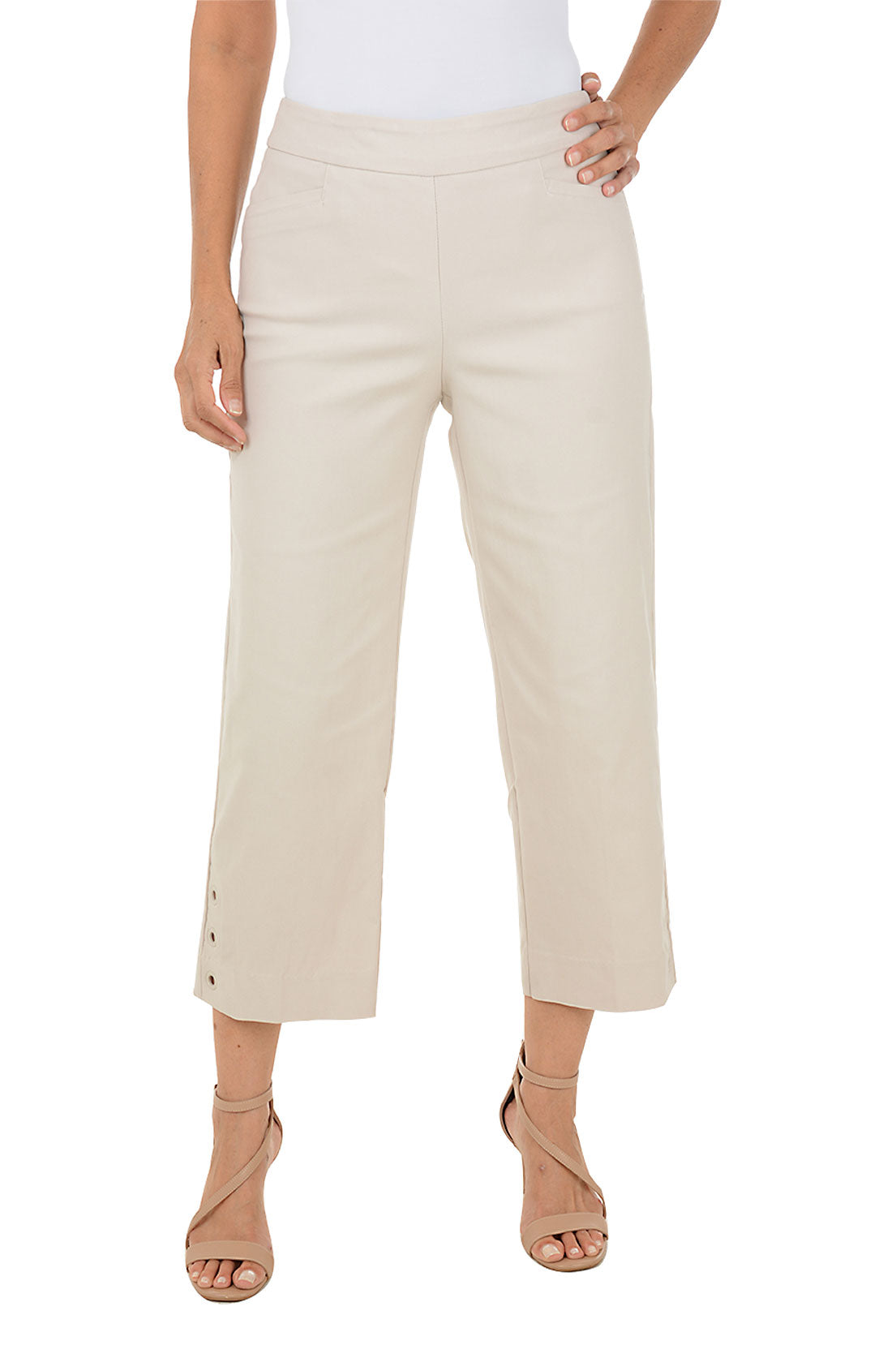 Beige crop pants worn by a person on a white background