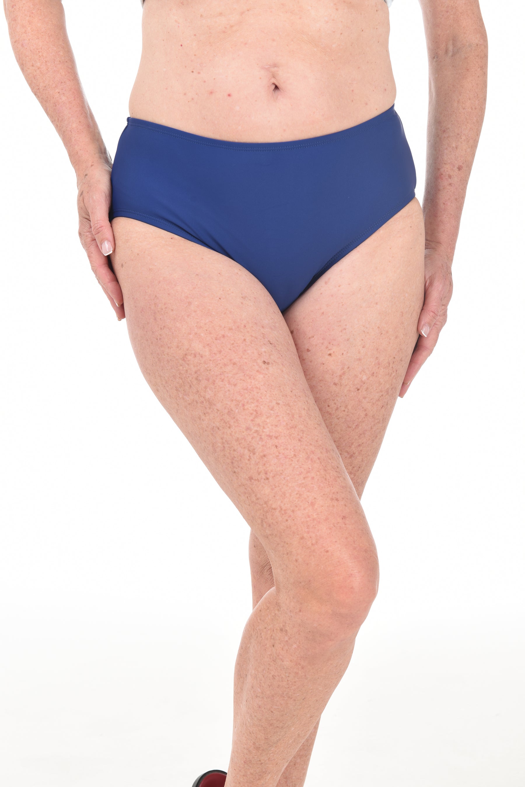Person wearing a blue bikini bottom on a white background.