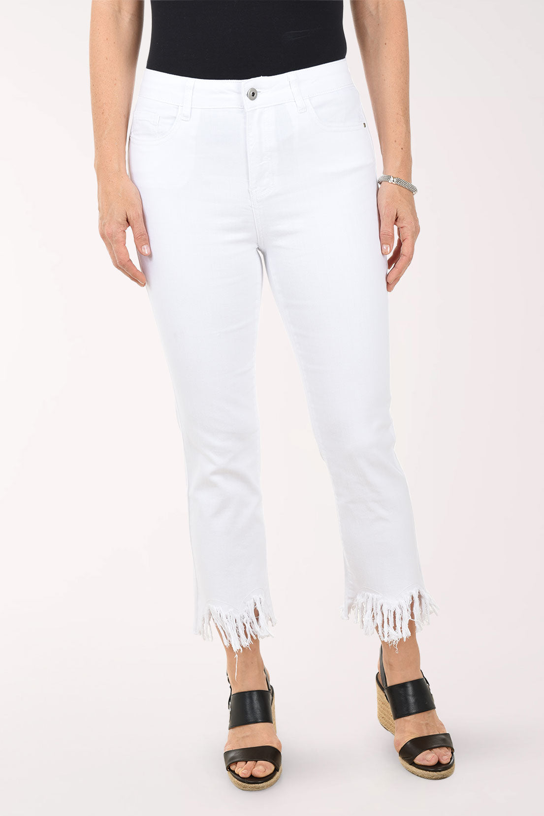 White jeans with frayed hems worn by a person on a white background