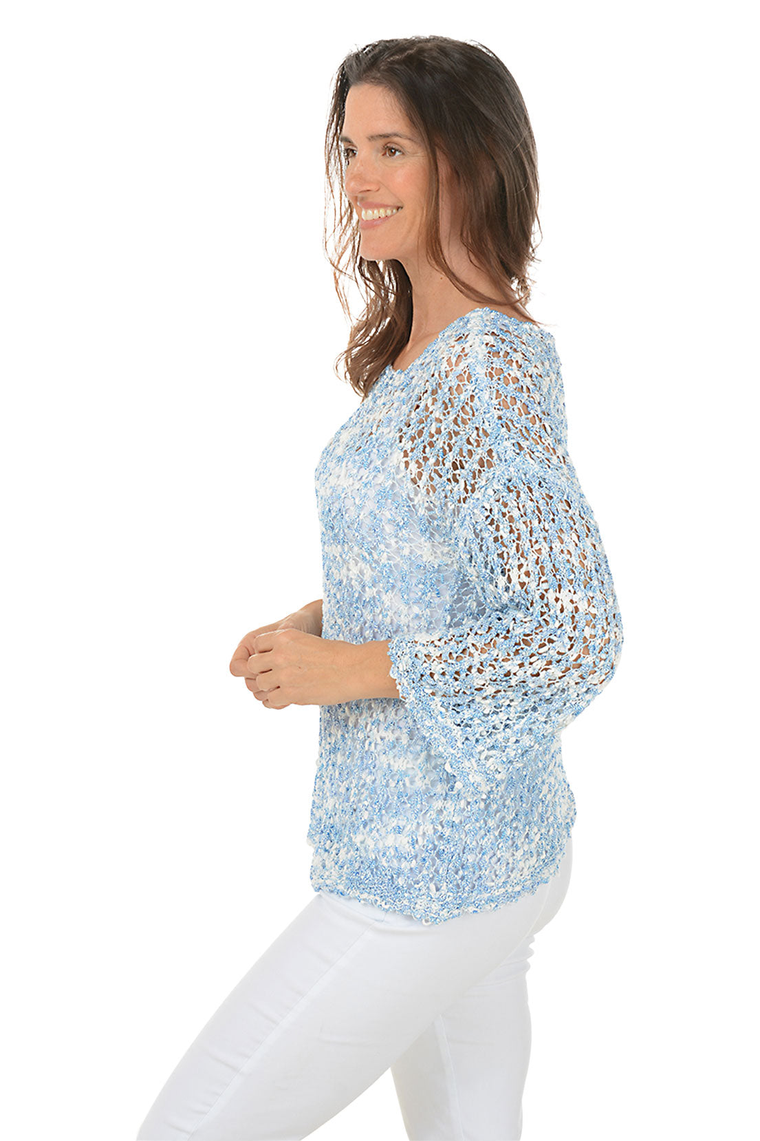 A woman wearing a blue open weave design crewneck sweater with 3/4-length dolman bell sleeves and drop shoulders. Side shot.