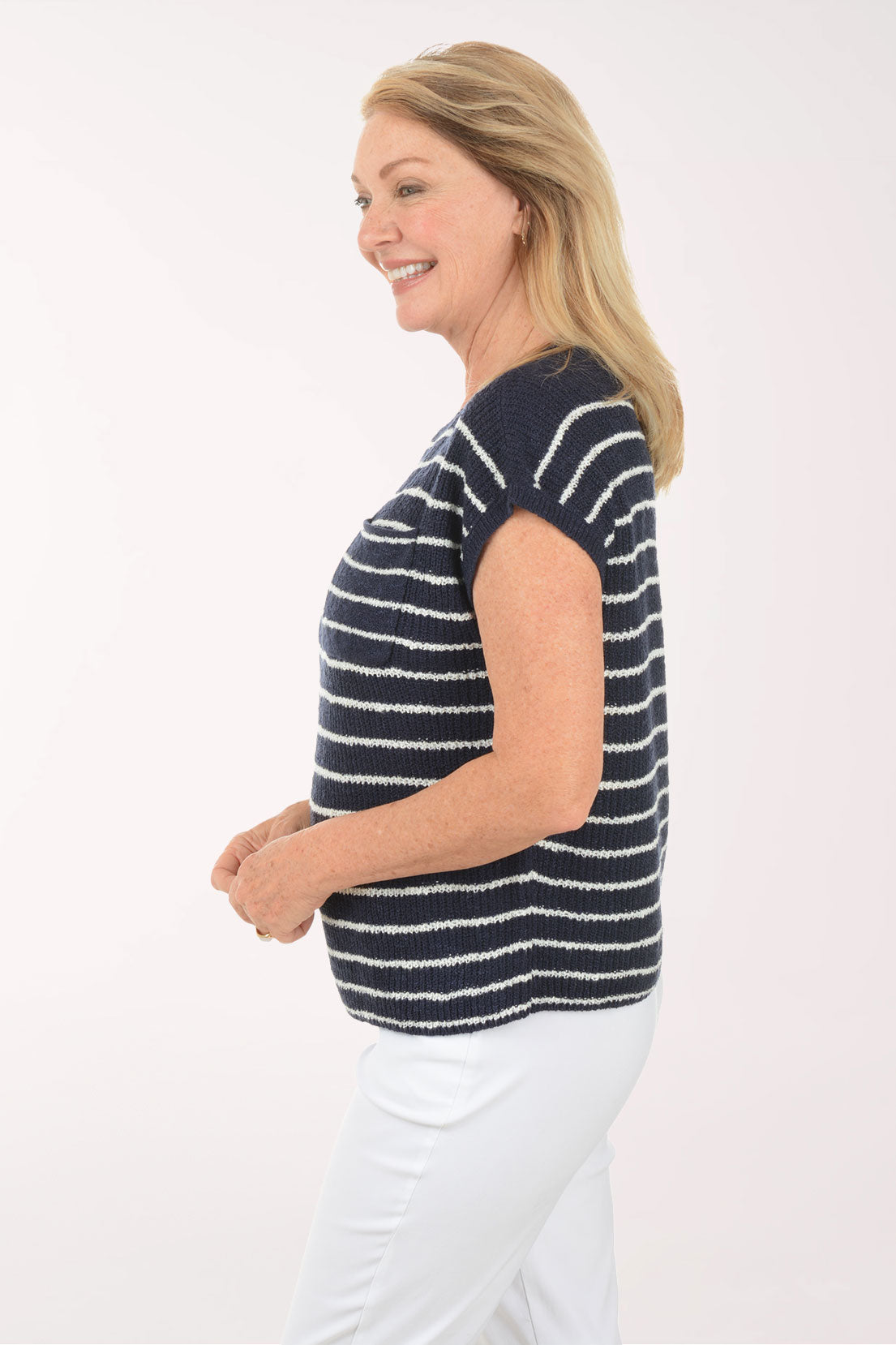 Woman wearing a navy and white striped shirt on a white background