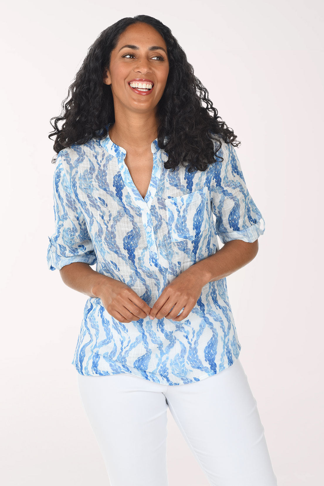 Woman wearing a blue patterned blouse against a white background