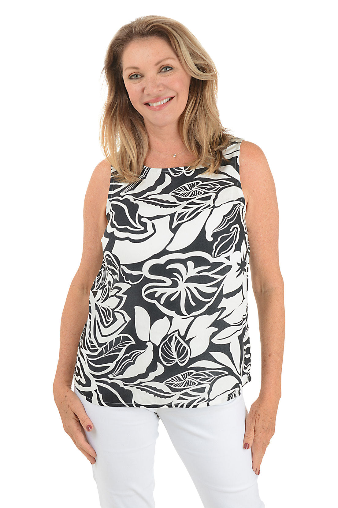 A woman wearing a sleeveless blouse with a leaf pattern, scoop neckline, and keyhole detail on the upper back.