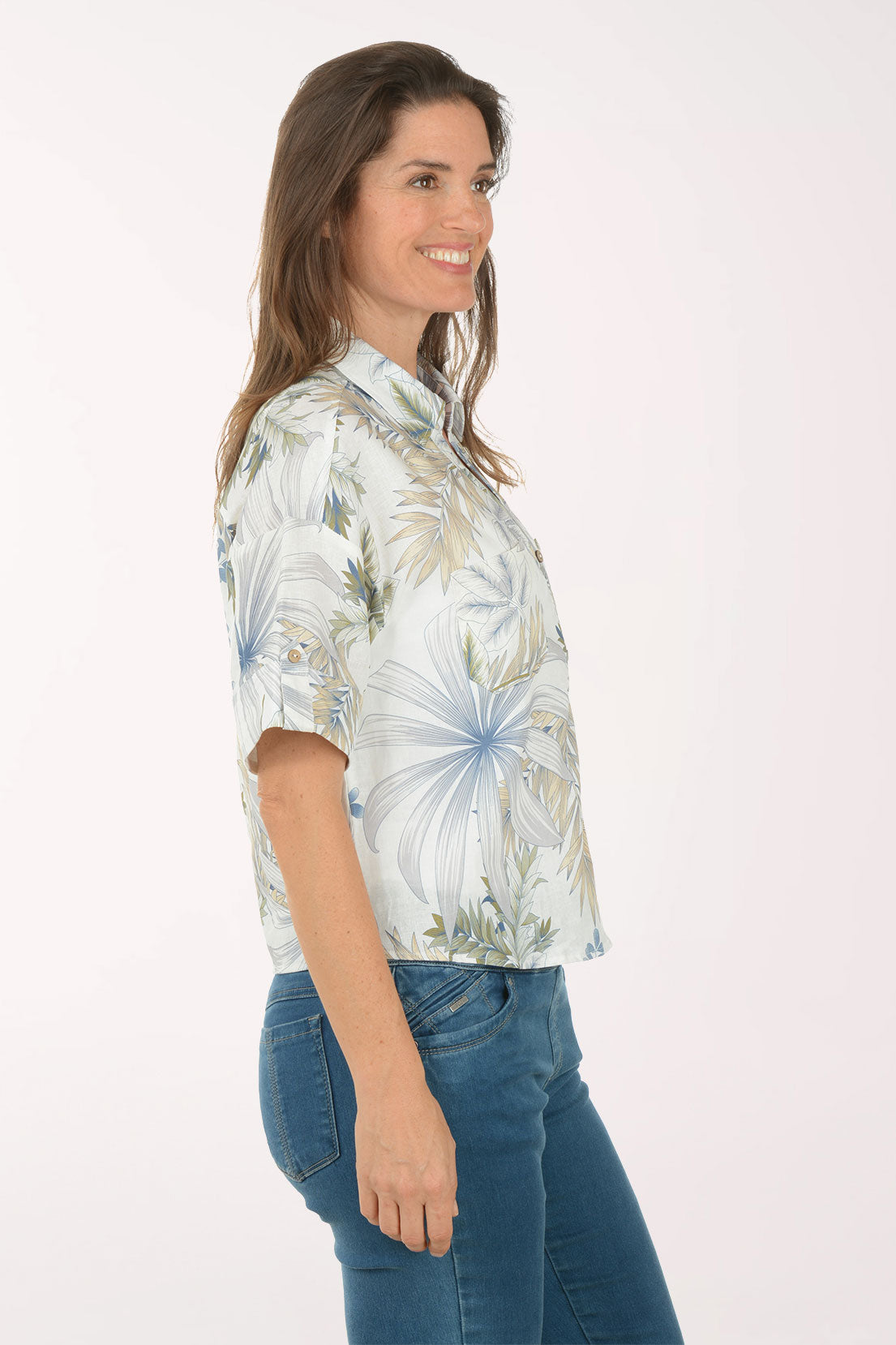 Woman wearing a floral shirt with a white background