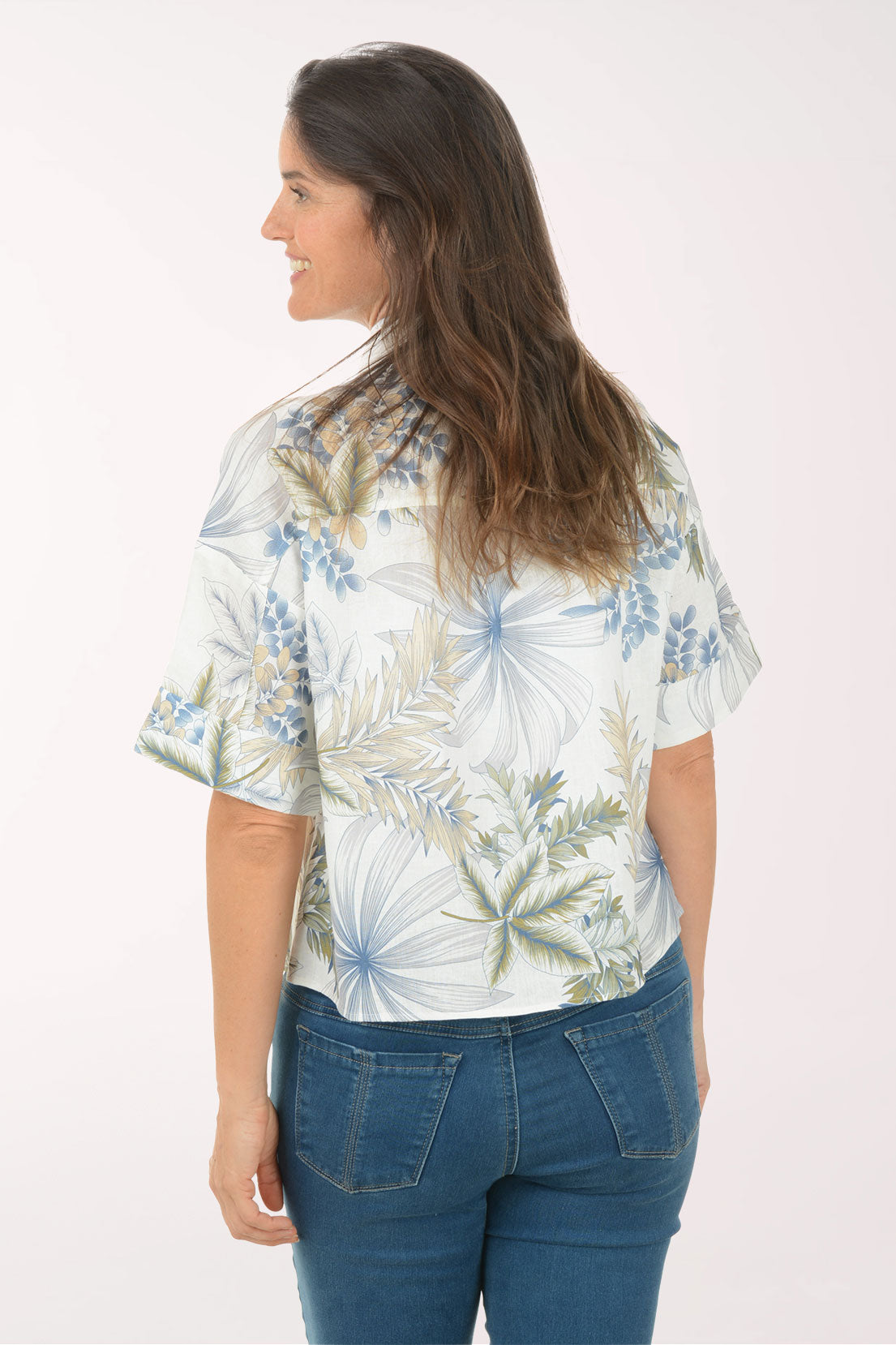 Woman wearing a floral shirt with a white background