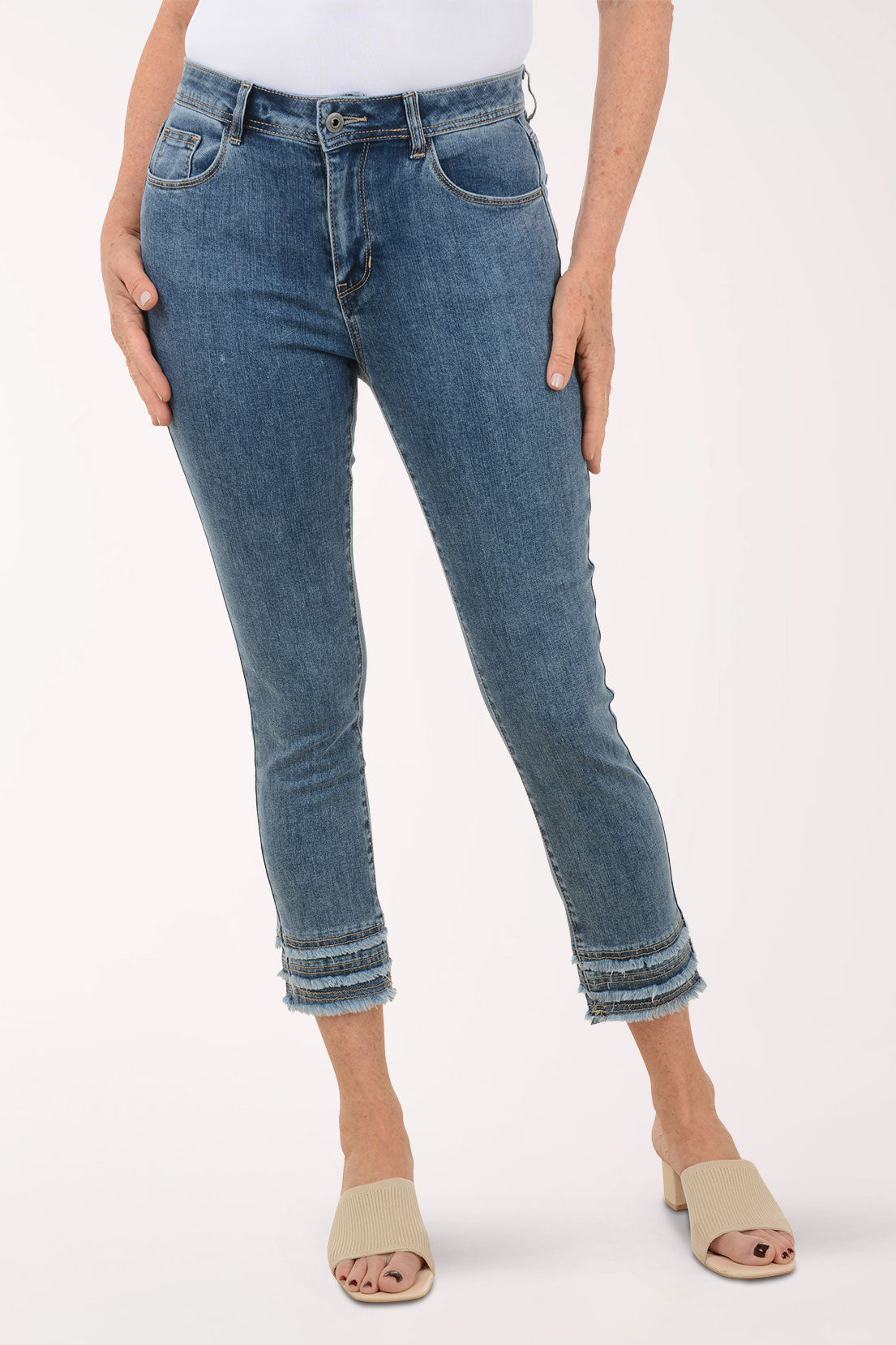 Person wearing blue jeans on a white background