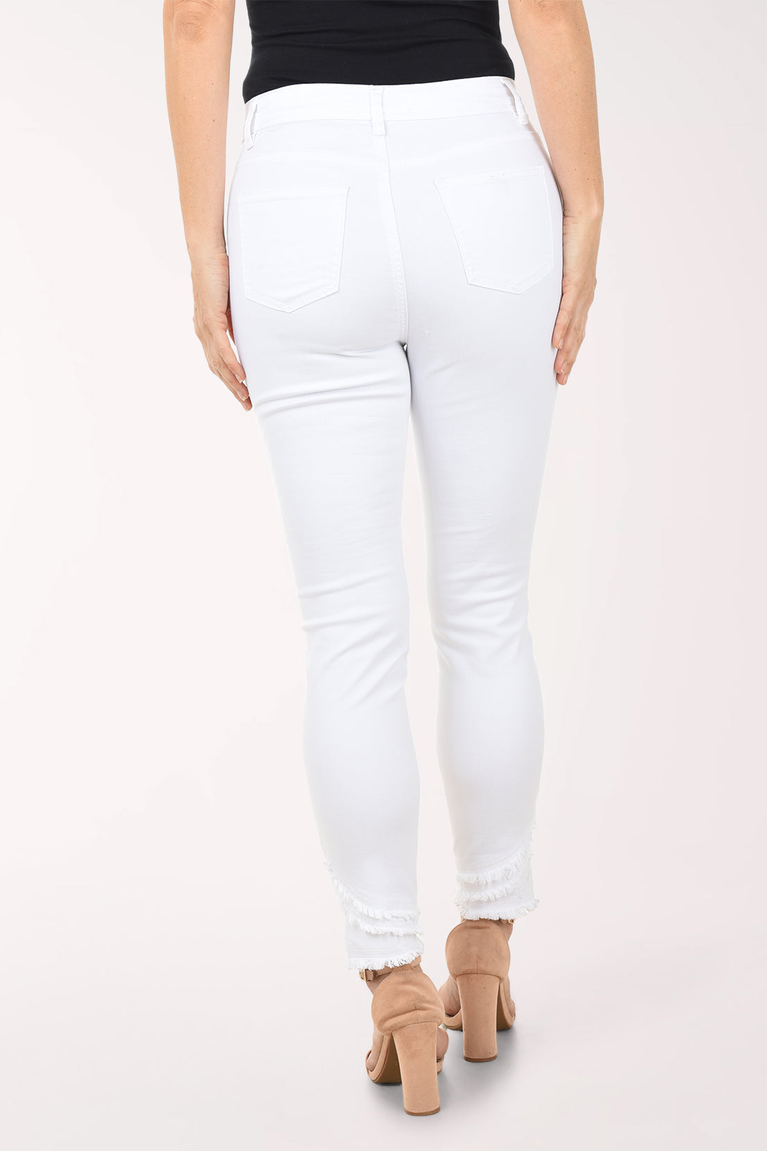 White jeans worn by a person on a white background
