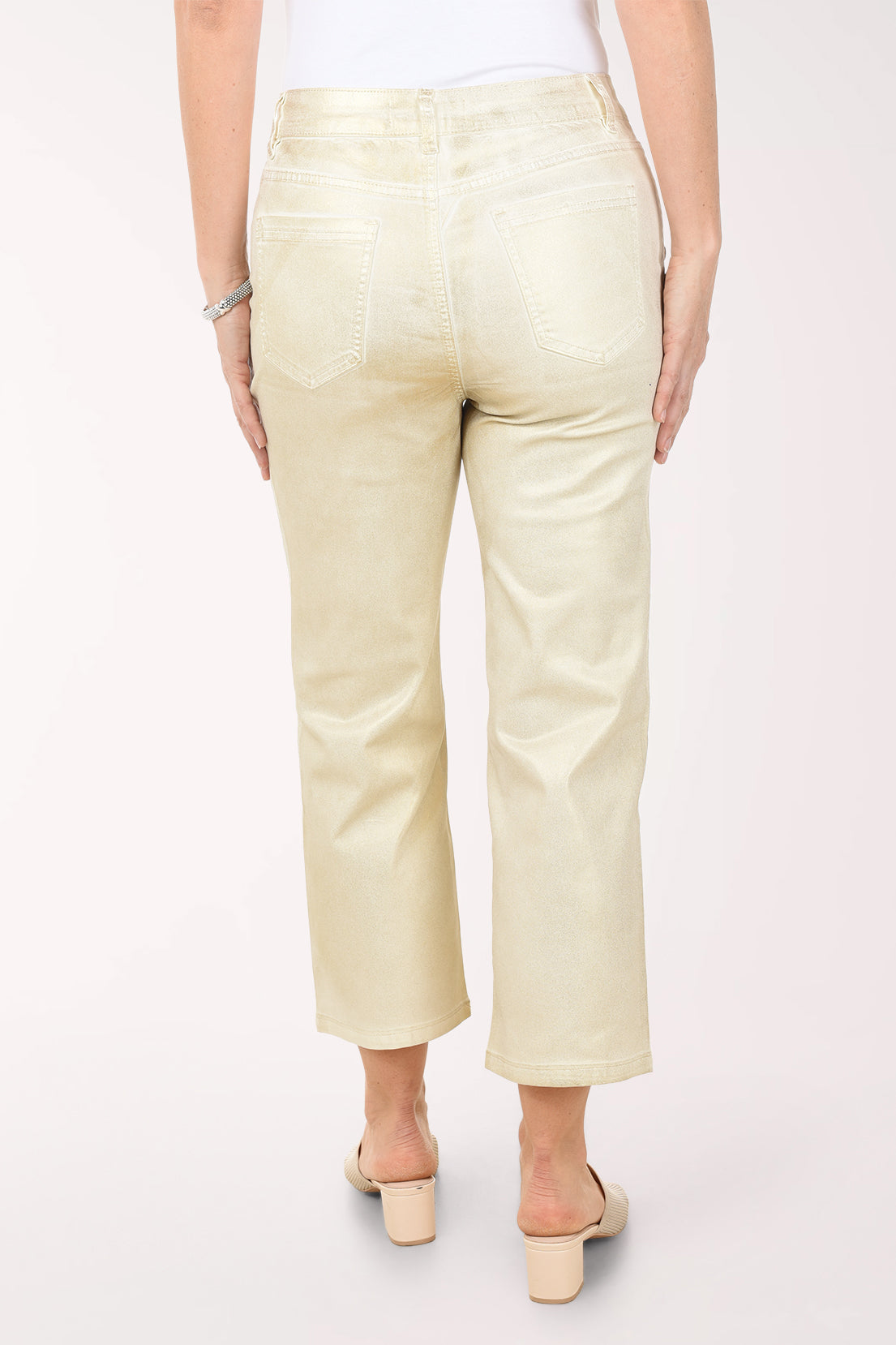 Person wearing light-colored pants on a white background