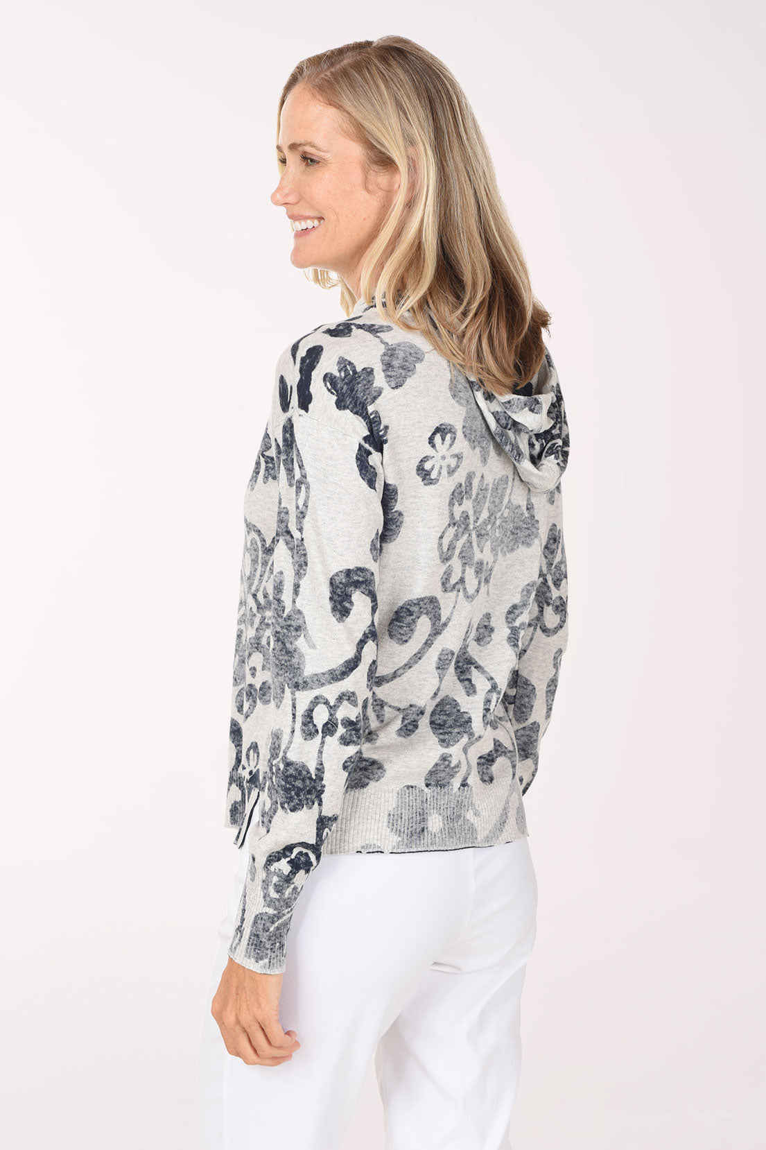 A back three-quarter view of the floral print hoodie showing the hood.