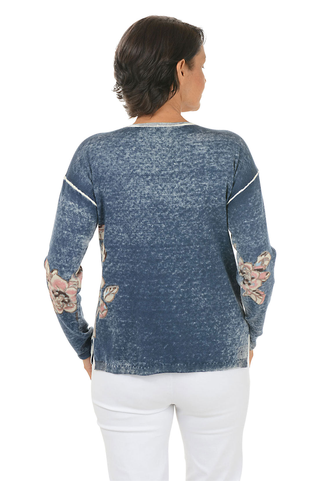 Woman wearing a blue floral-patterned sweater on a white background. Back shot.