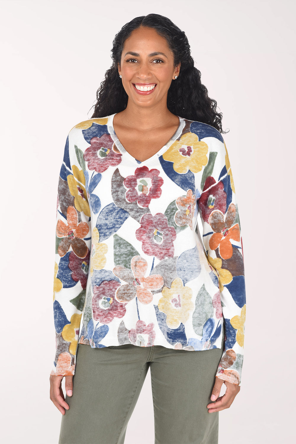Woman wearing a long sleeve v-neck sweater with multi floral print