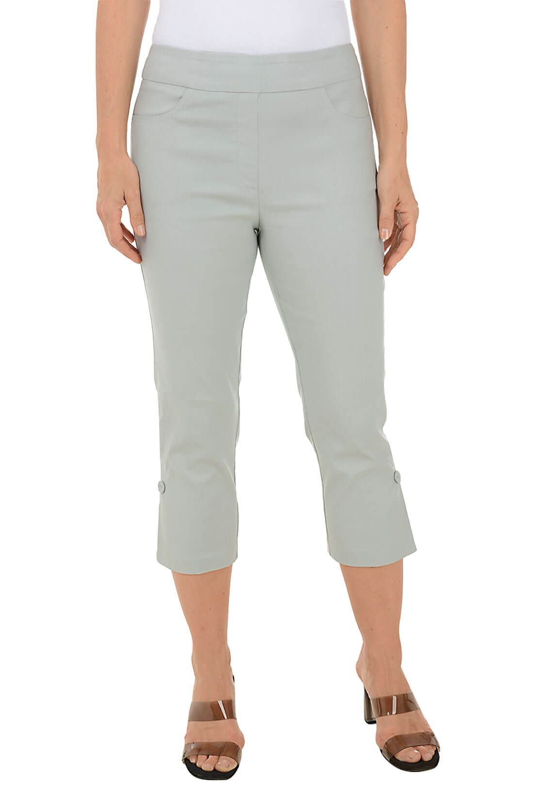 A model wearing grey pull-on capri pants with an elasticized waistband, dual front and back pockets, and fabric-covered buttons at the hemline.