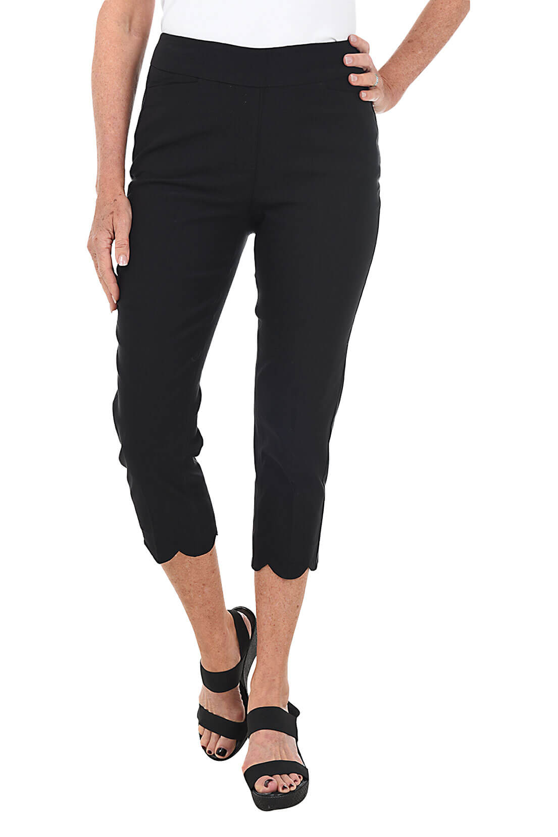 Person wearing black capri pants on a white background front shot.