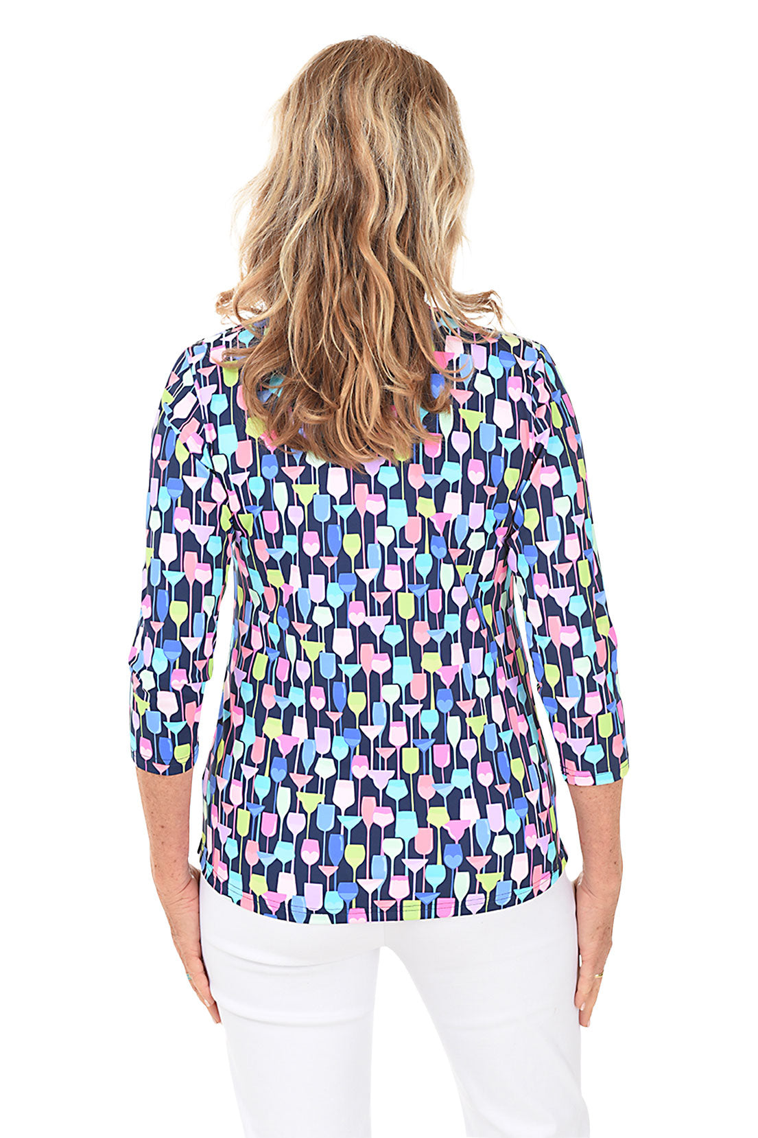 A woman wearing a multicolored geometric wine patterned V-neck top with 3/4 sleeves. Back shot.