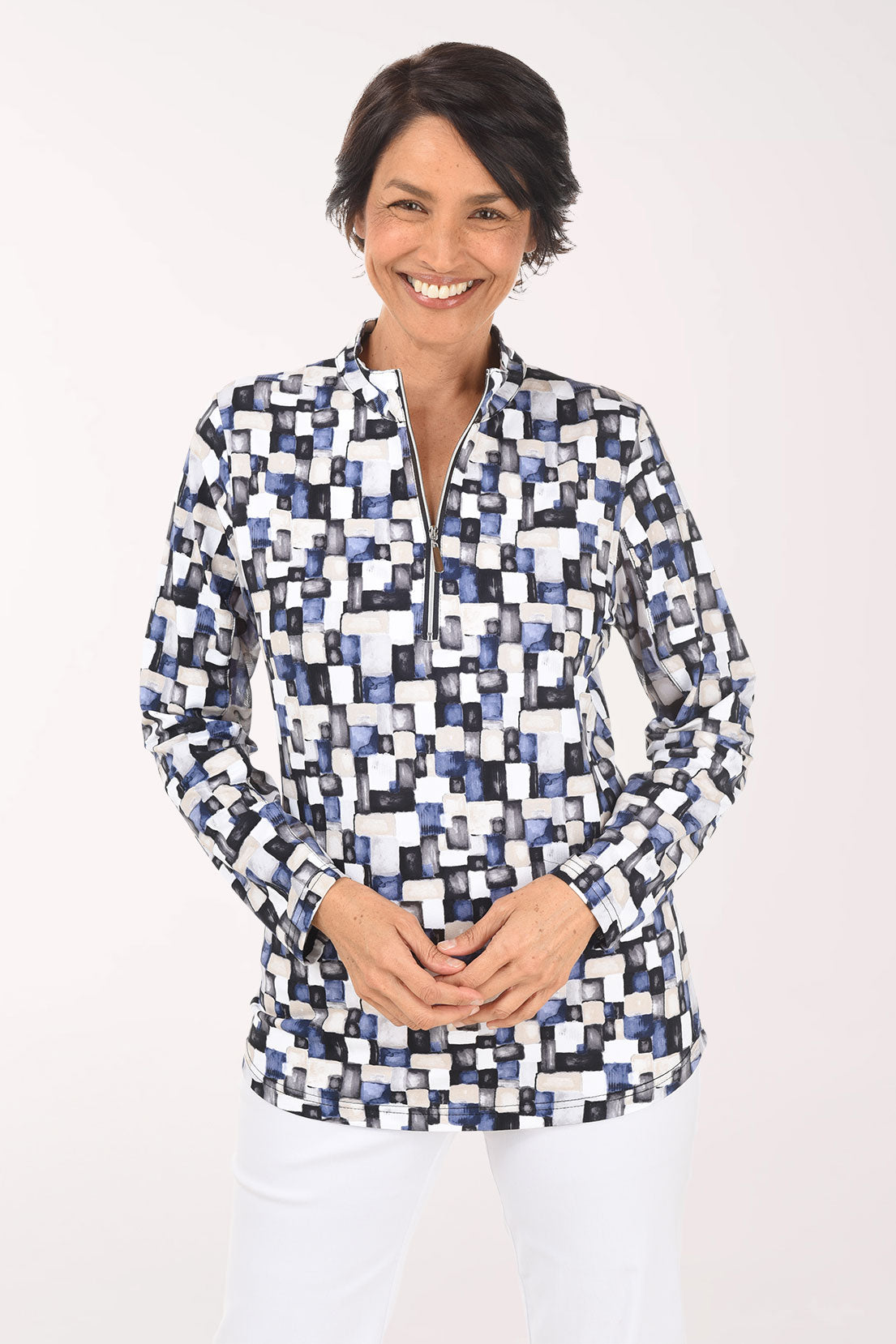 Woman wearing a patterned blouse on a white background