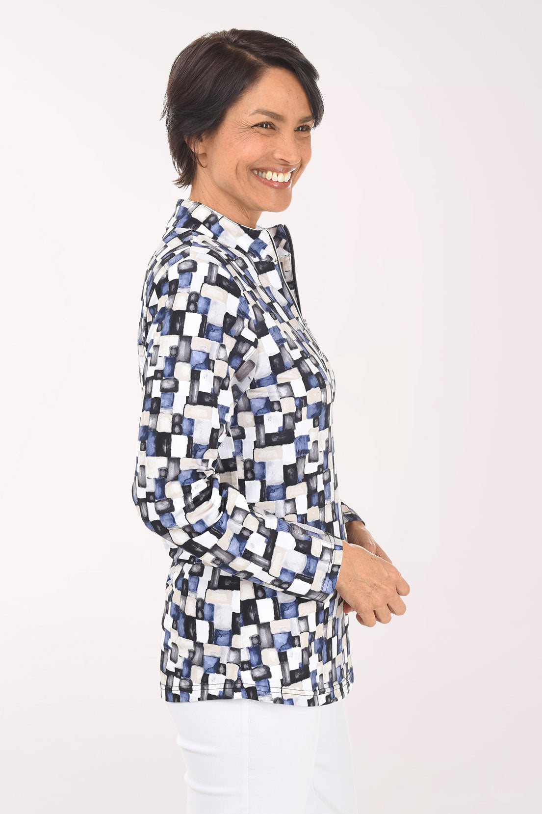 Woman wearing a patterned blouse on a white background