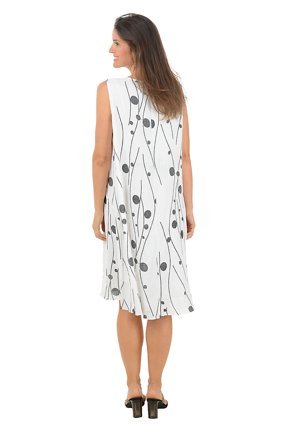 Woman wearing a white dress with black patterns on a white background