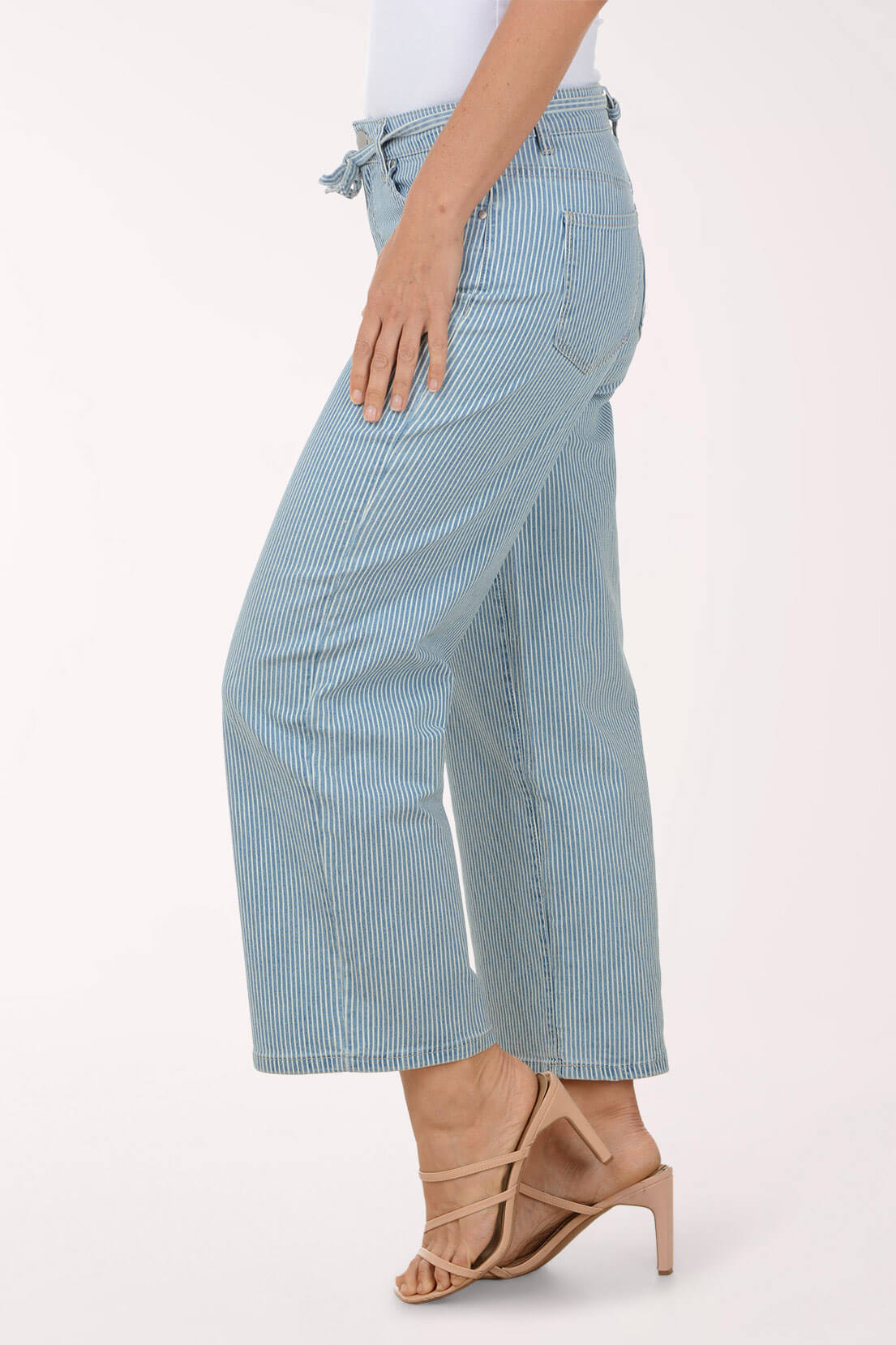Light blue and white striped pants worn by a person on a white background