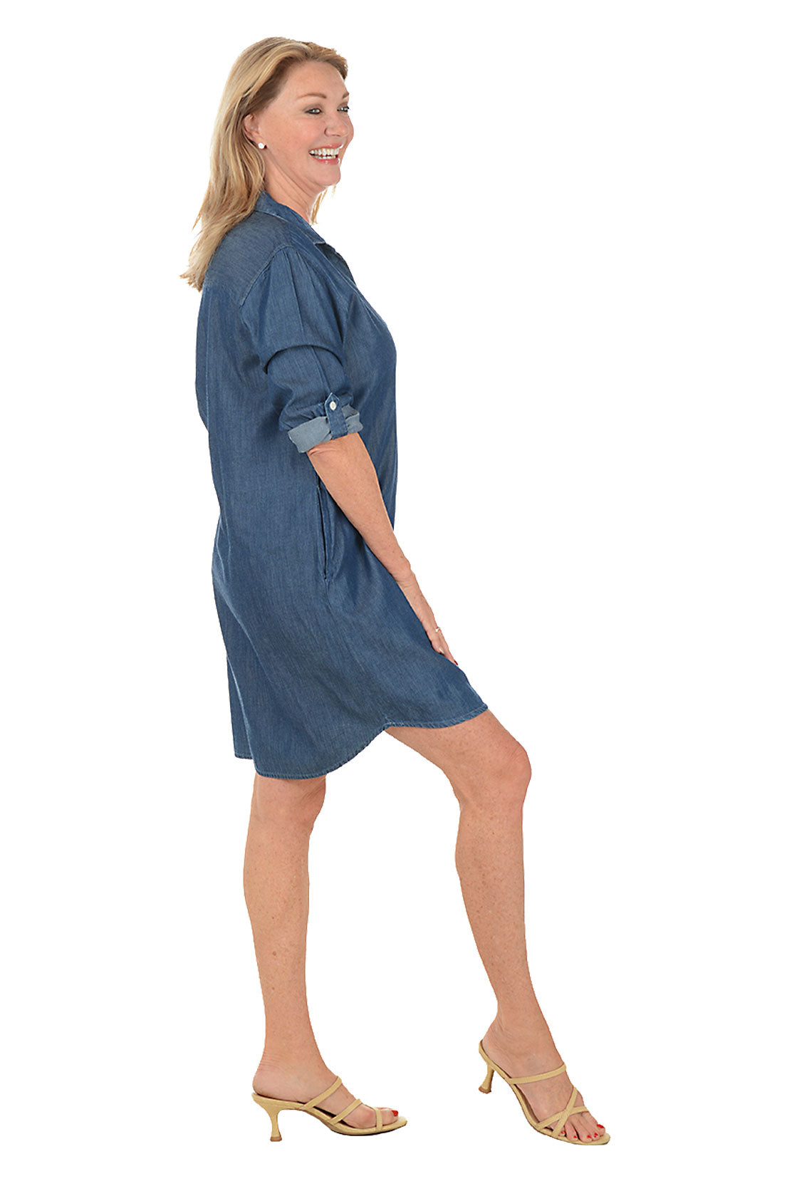 Woman wearing a blue denim dress on a white background
