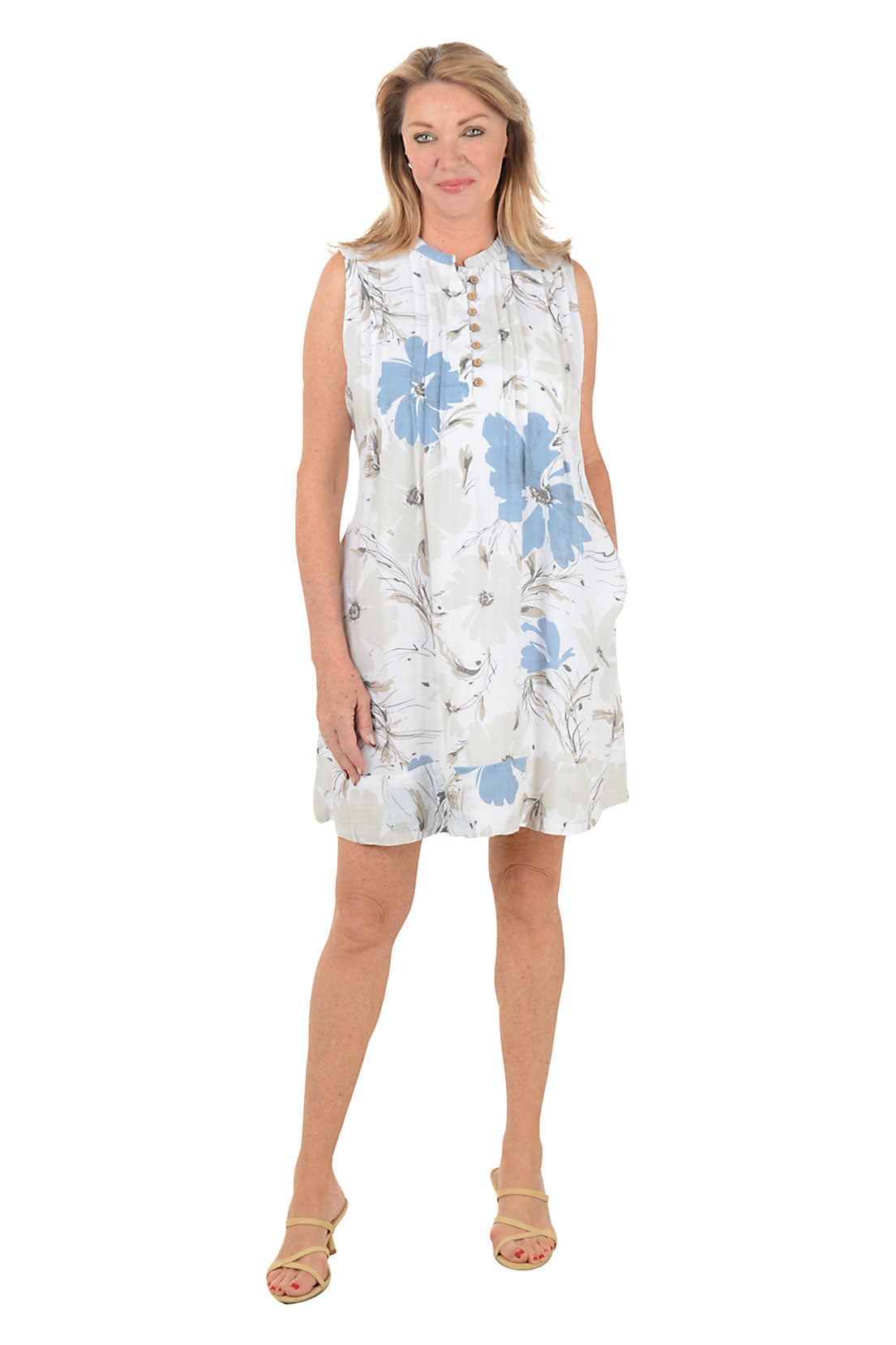 Woman wearing a sleeveless floral dress on a white background