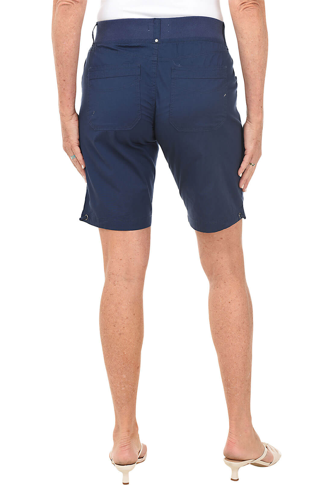 Navy blue shorts worn by a person on a white background