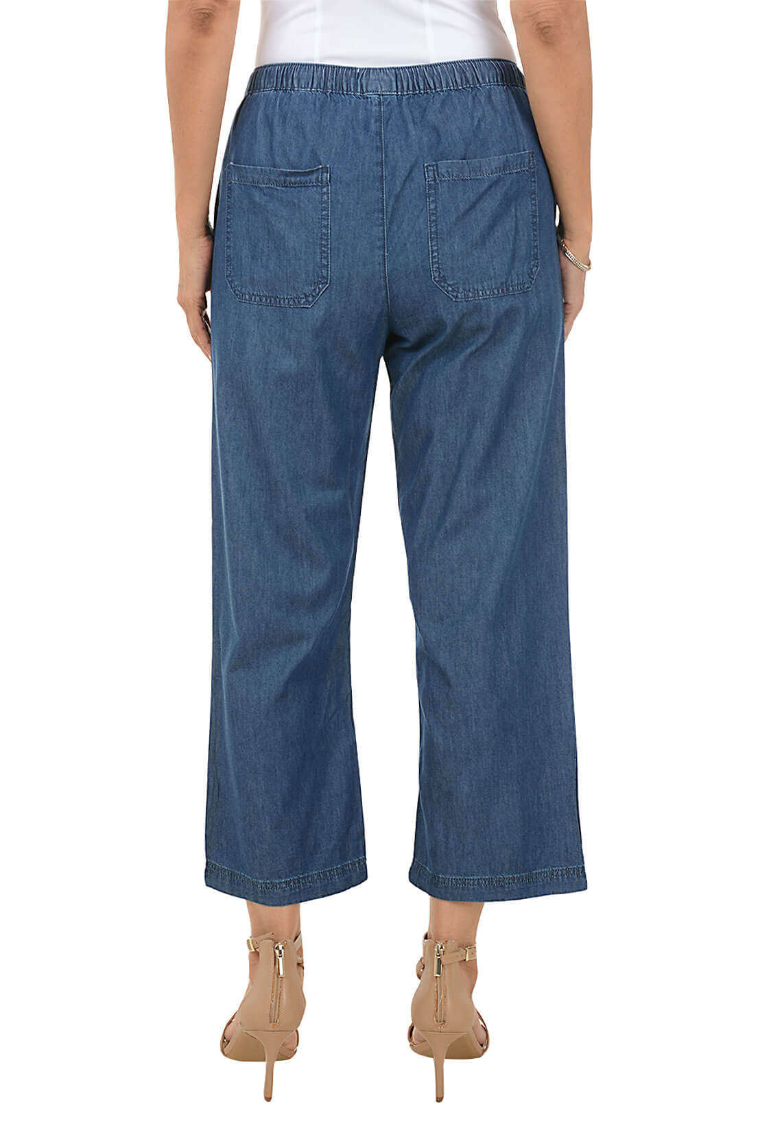 Blue denim pants worn by a person on a white background
