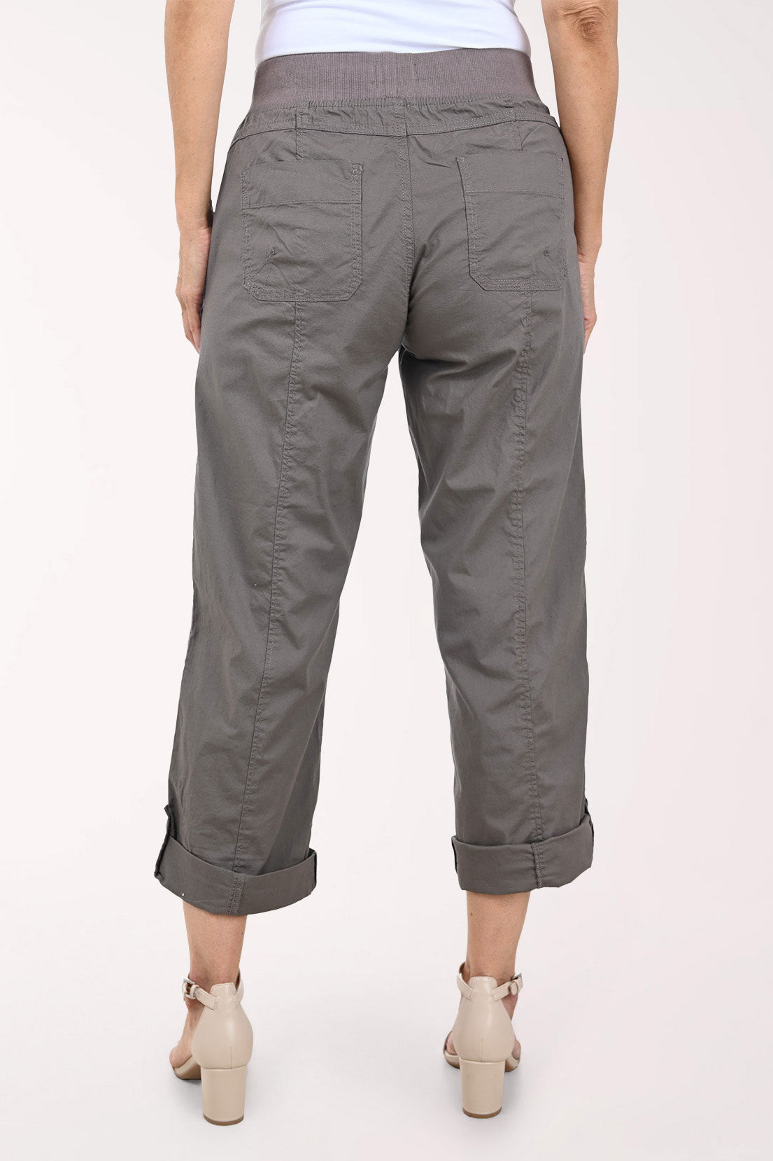 A person wearing dark gray drawstring cropped pants with rolled cuffs, shown from the waist down against a plain light background.
