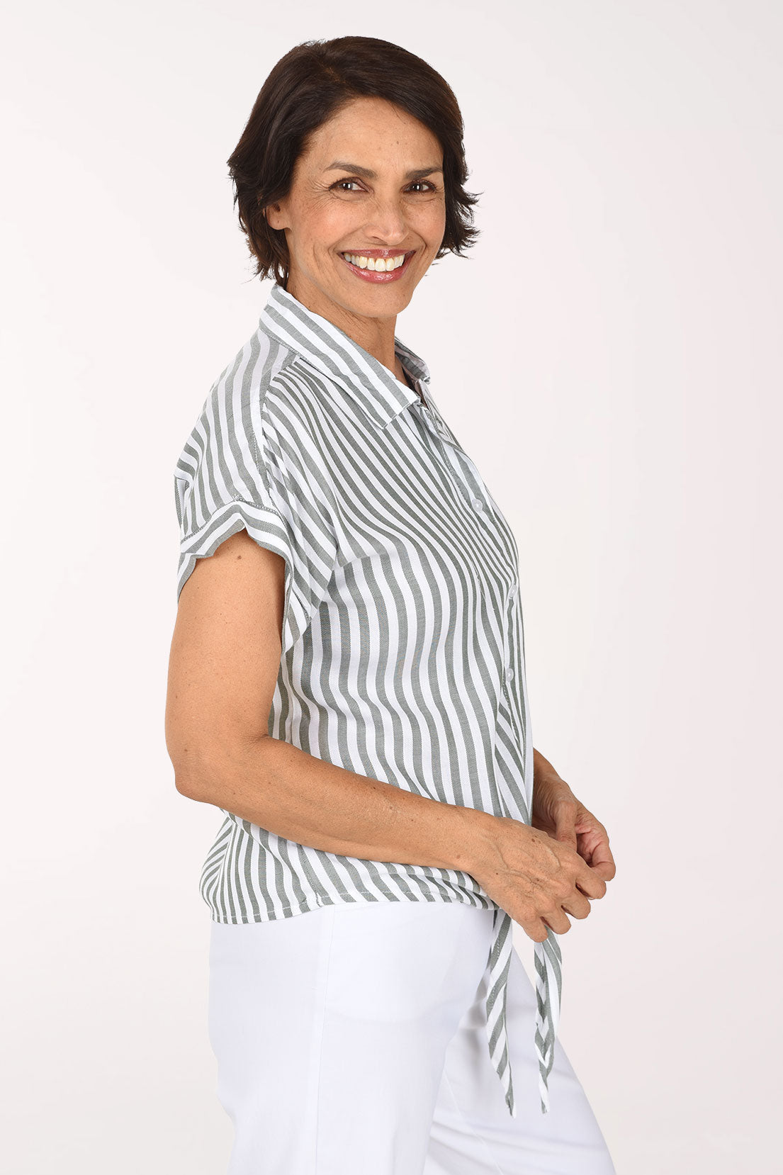 Woman wearing a seersucker olive green and white button down shirt with short sleeves and a tie bottom