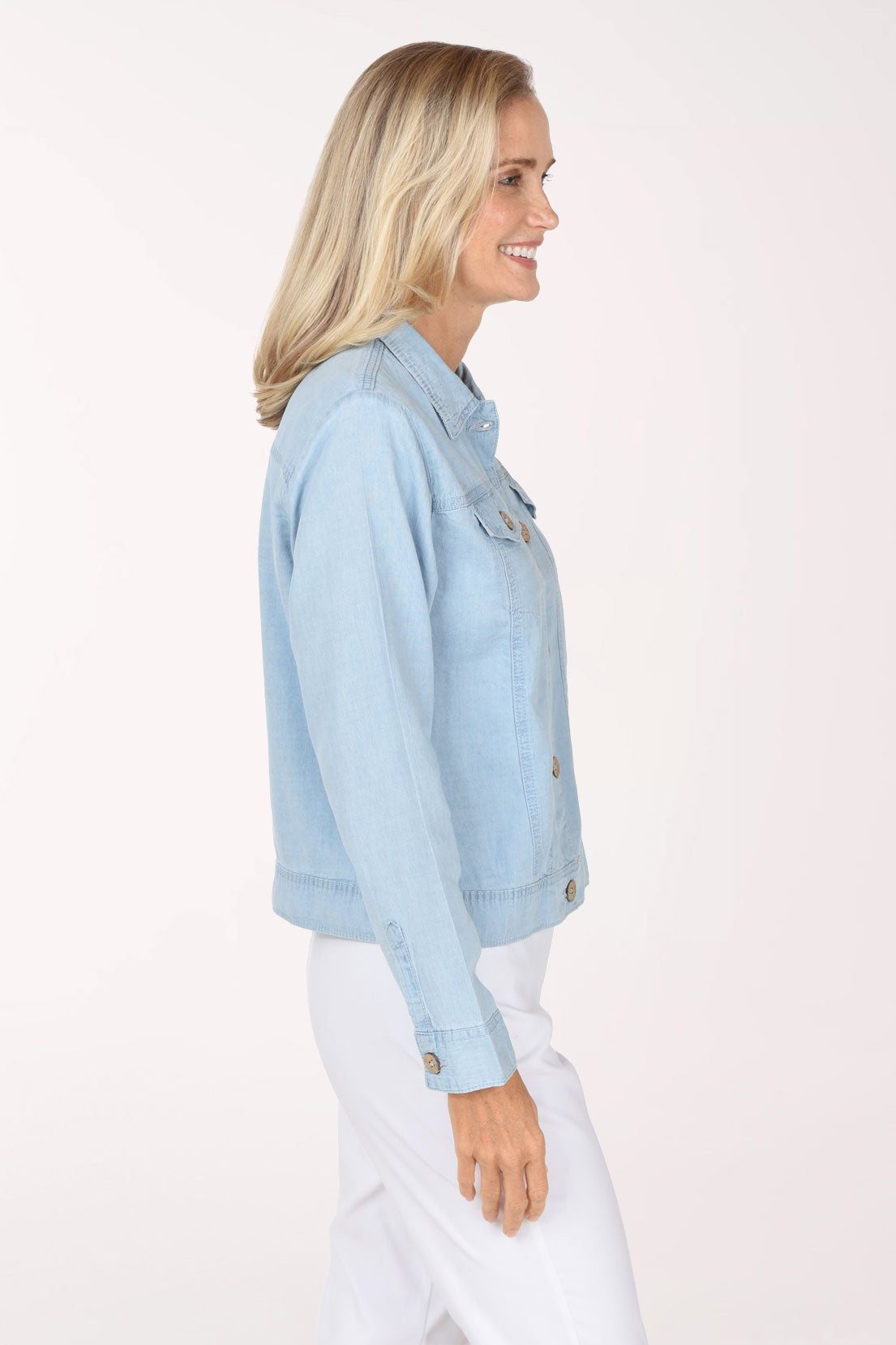 Woman wearing a light wash denim jacket