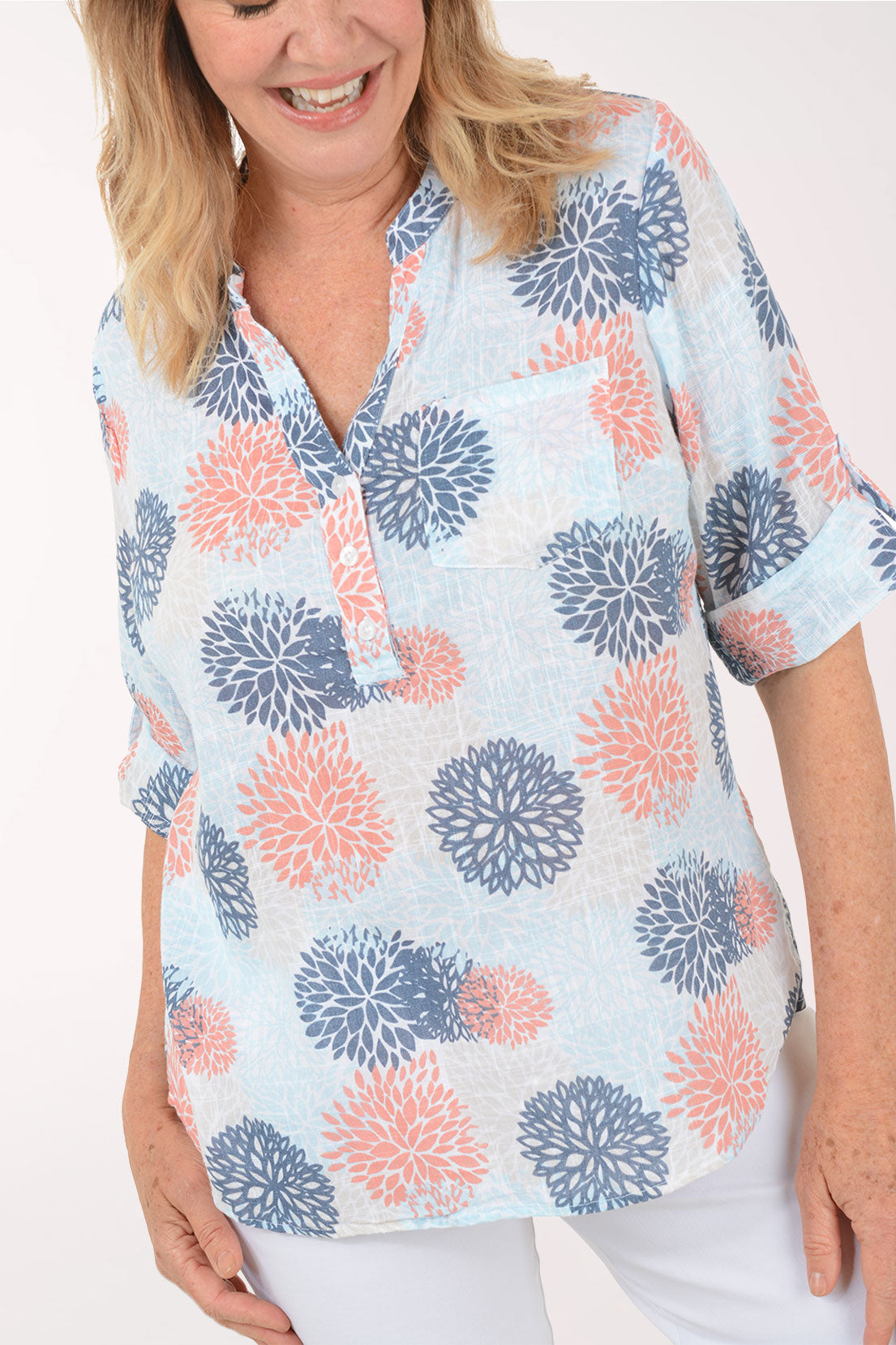 Woman wearing a blue and coral 3/4 sleeve henley top.