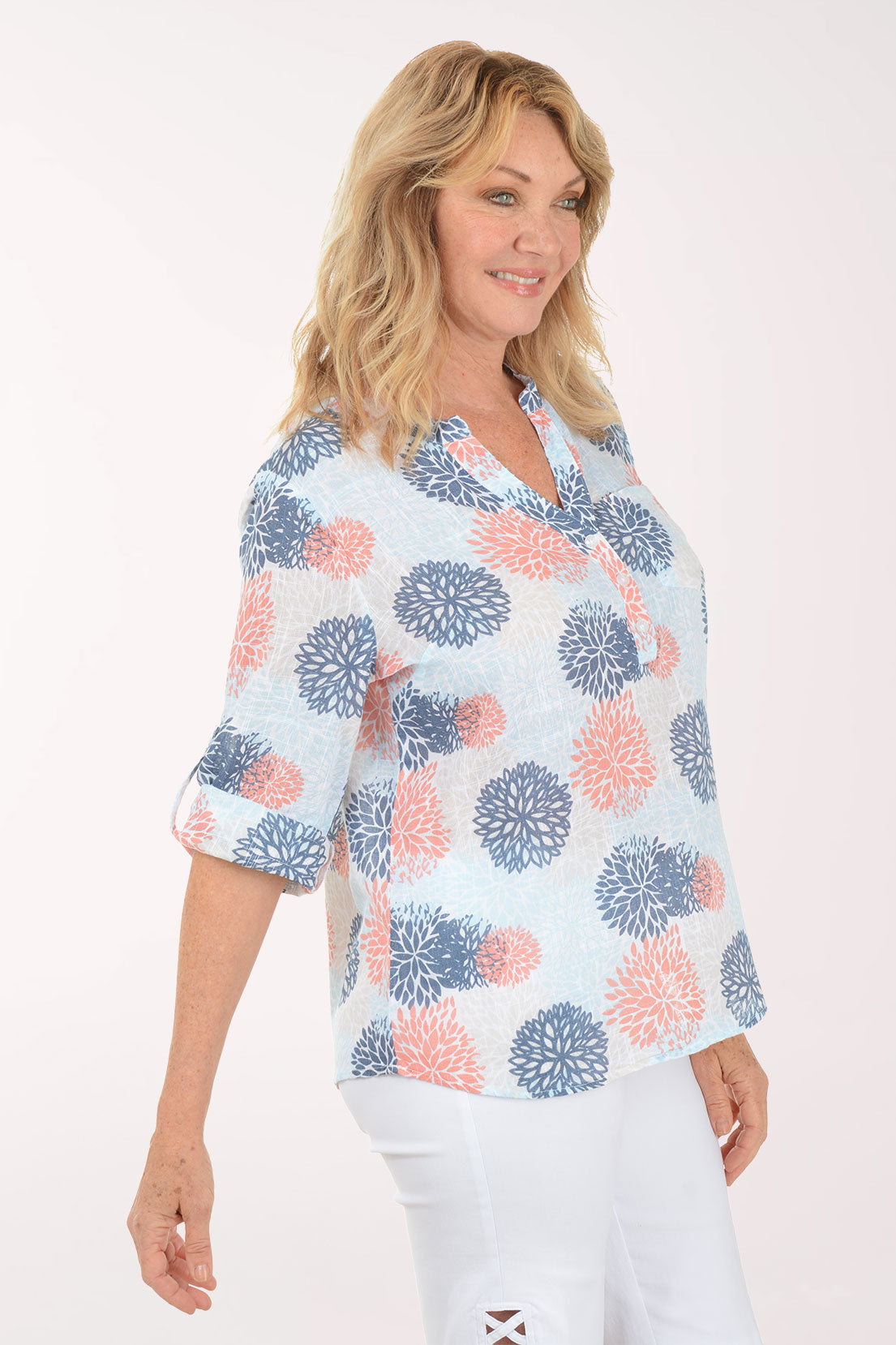Woman wearing a blue and coral 3/4 sleeve henley top.