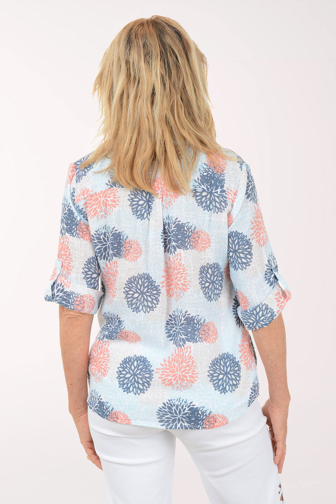 Woman wearing a blue and coral 3/4 sleeve henley top.
