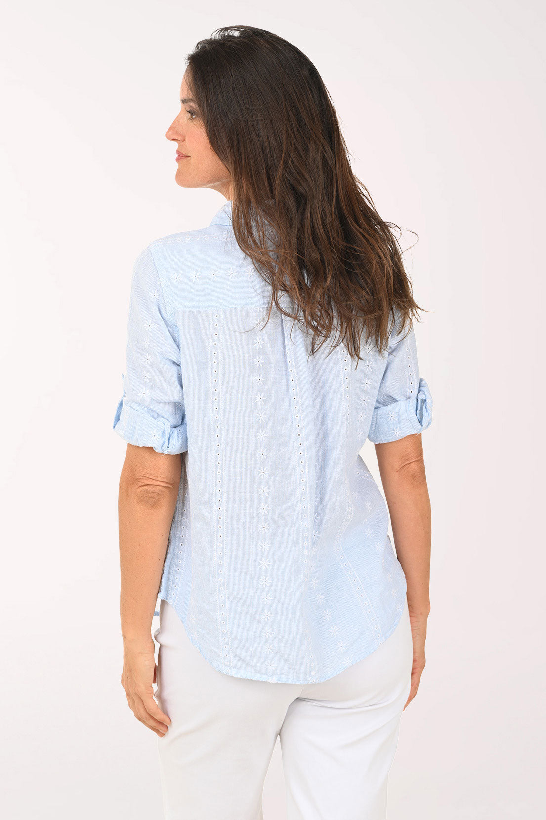 Woman wearing a chambray roll sleeve top.