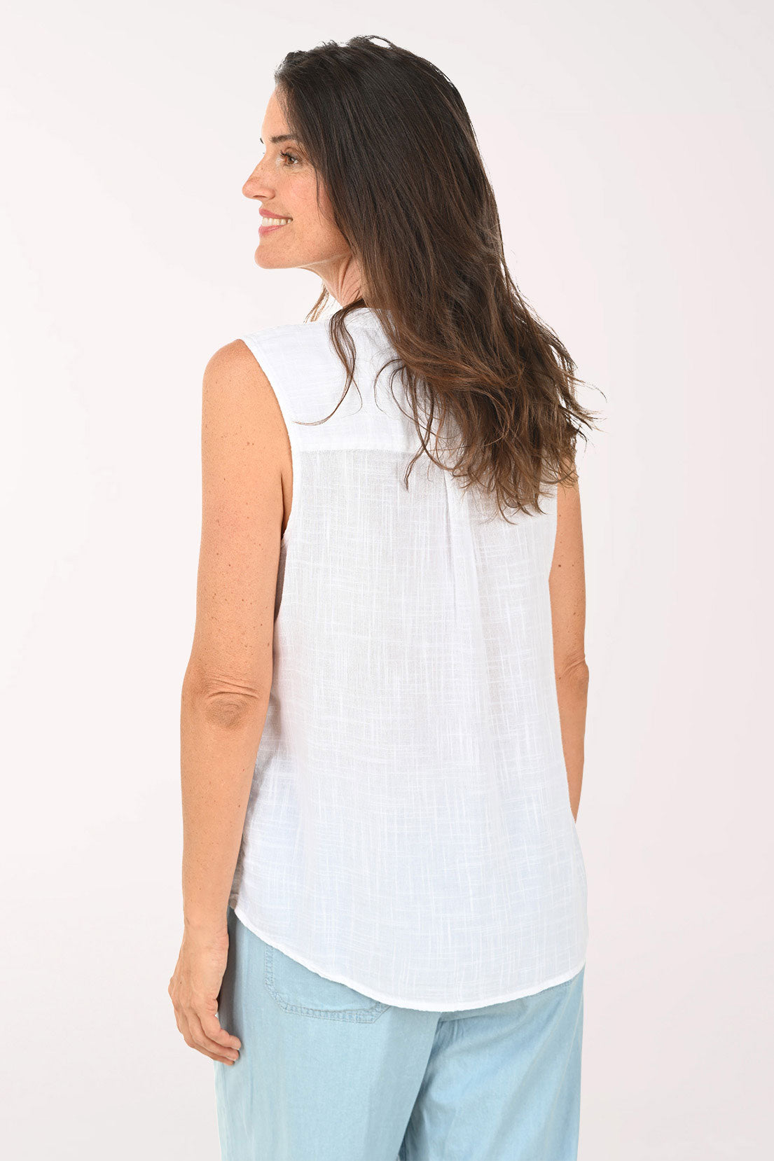 Woman wearing a white sleeveless top