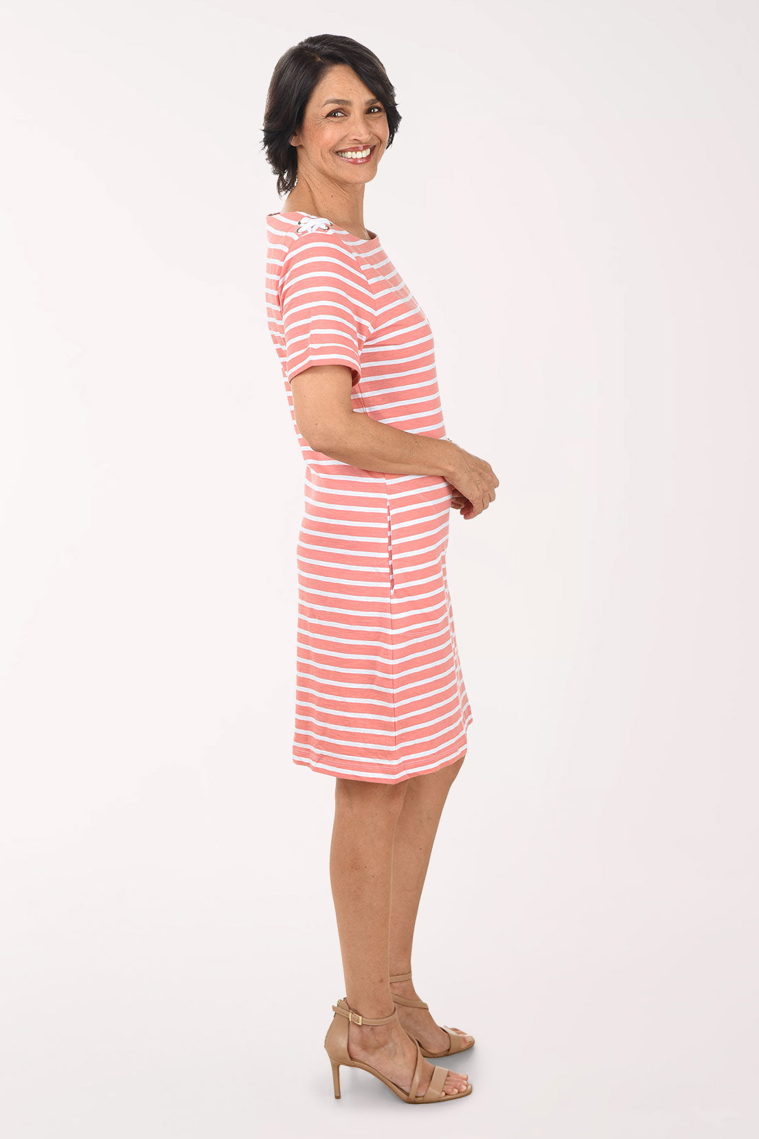 Woman wearing a red and white striped dress on a white background