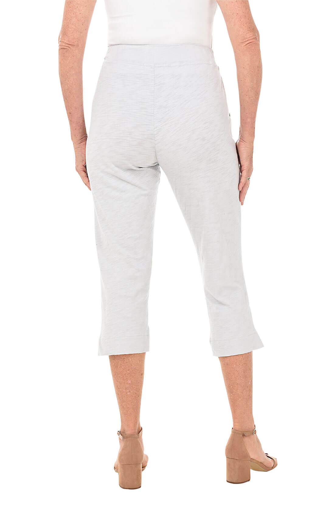Light grey capri pants worn by a person on a white background- back shot