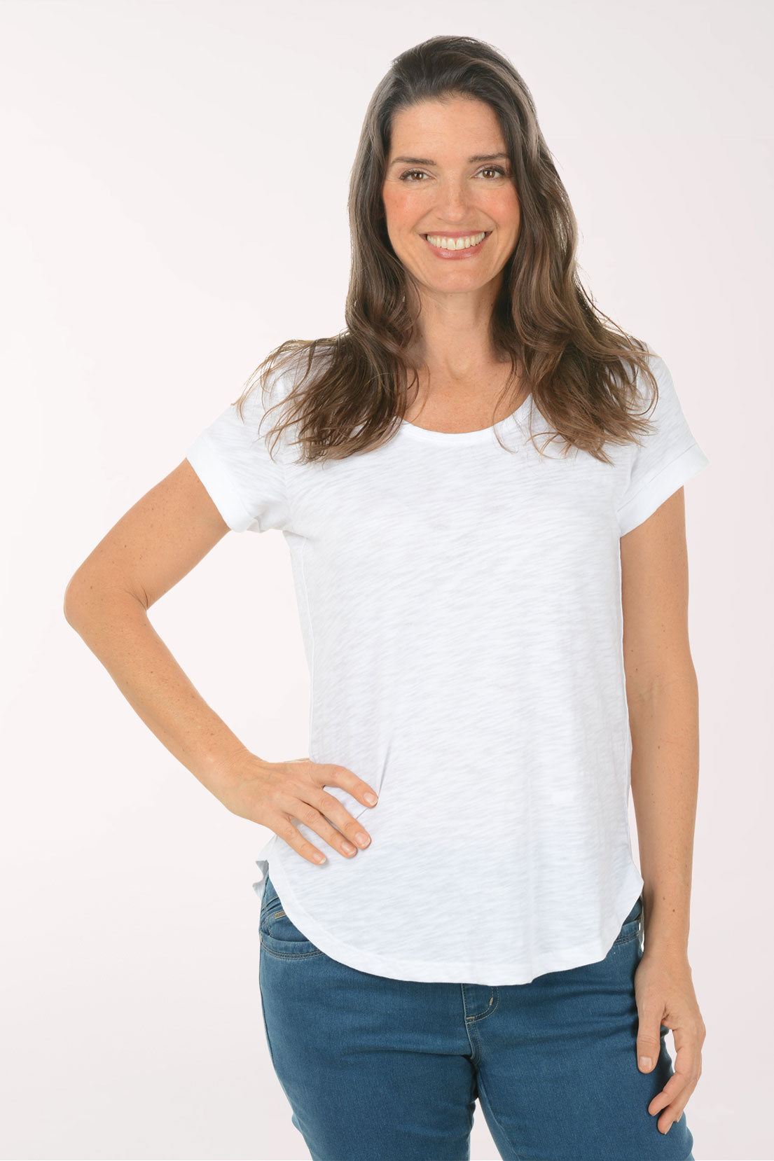 A woman wearing a short sleeve white top.