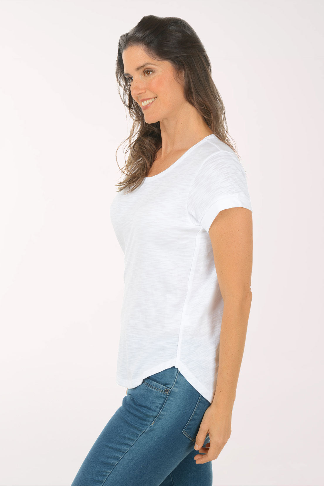 A woman wearing a short sleeve white top.