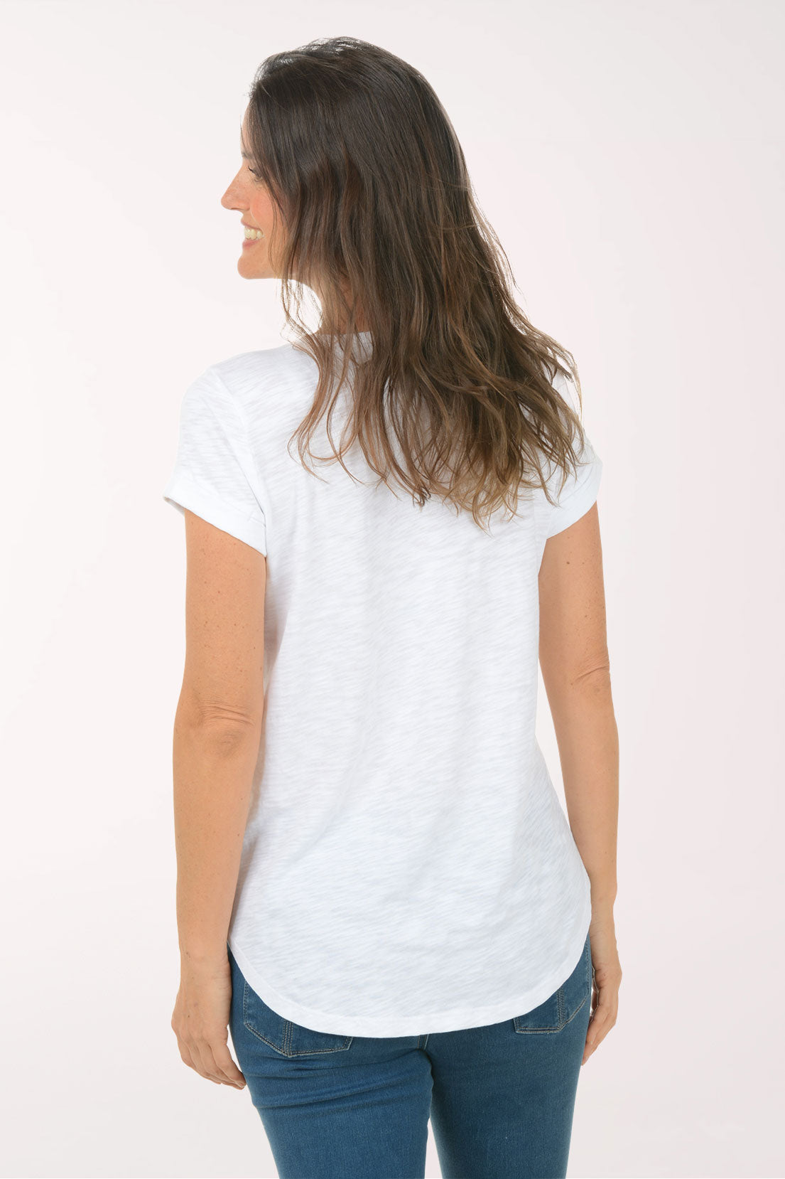 A woman wearing a short sleeve white top.