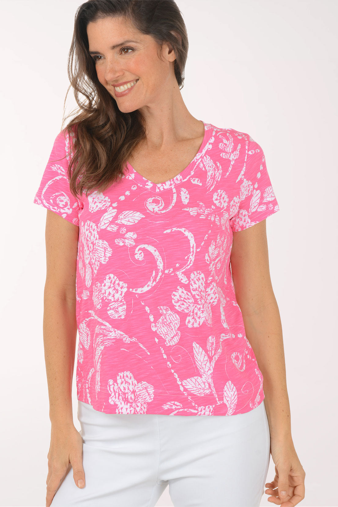 A woman wearing a short sleeve pink top.