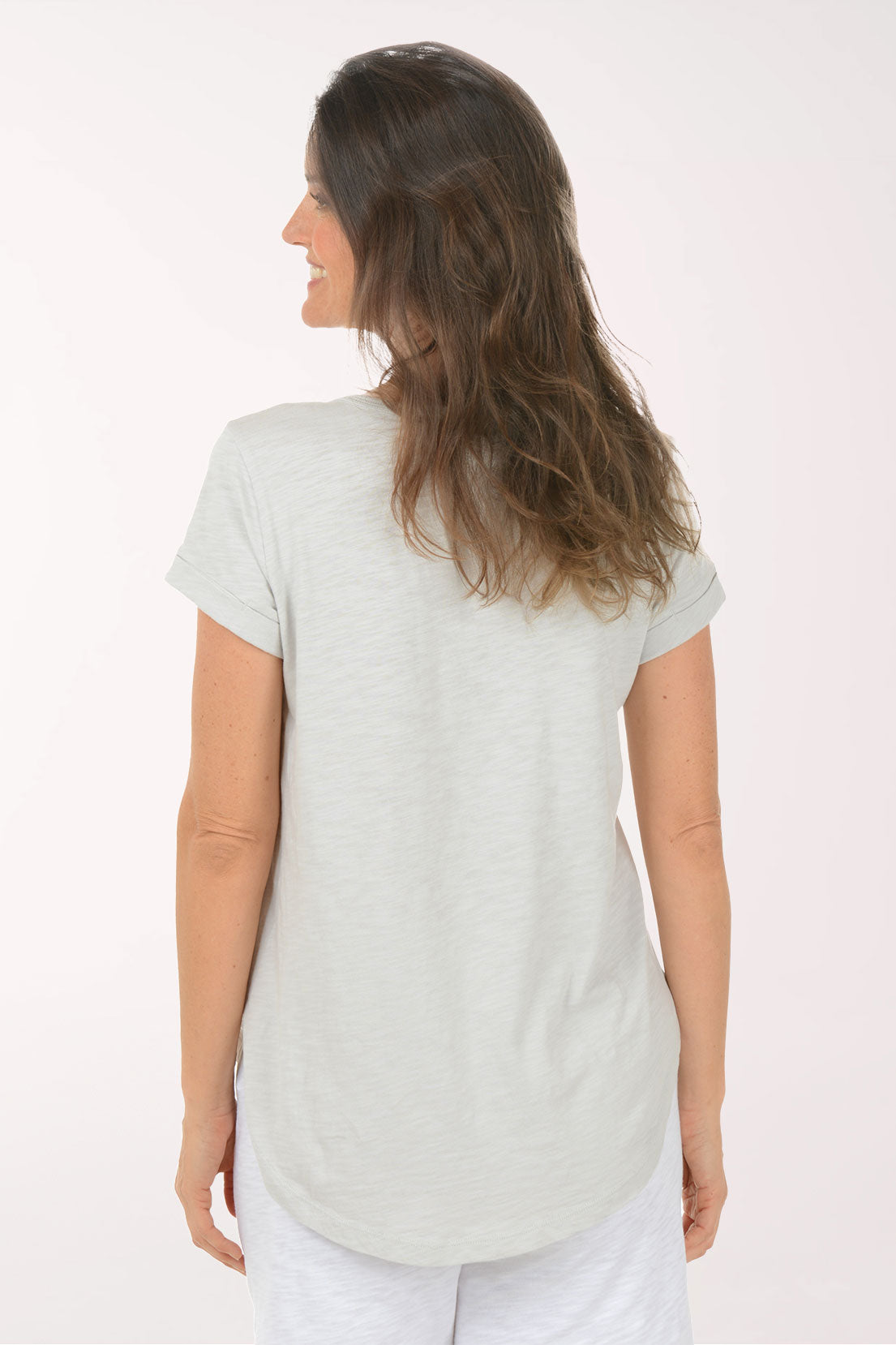 A woman wearing a short sleeve grey top.