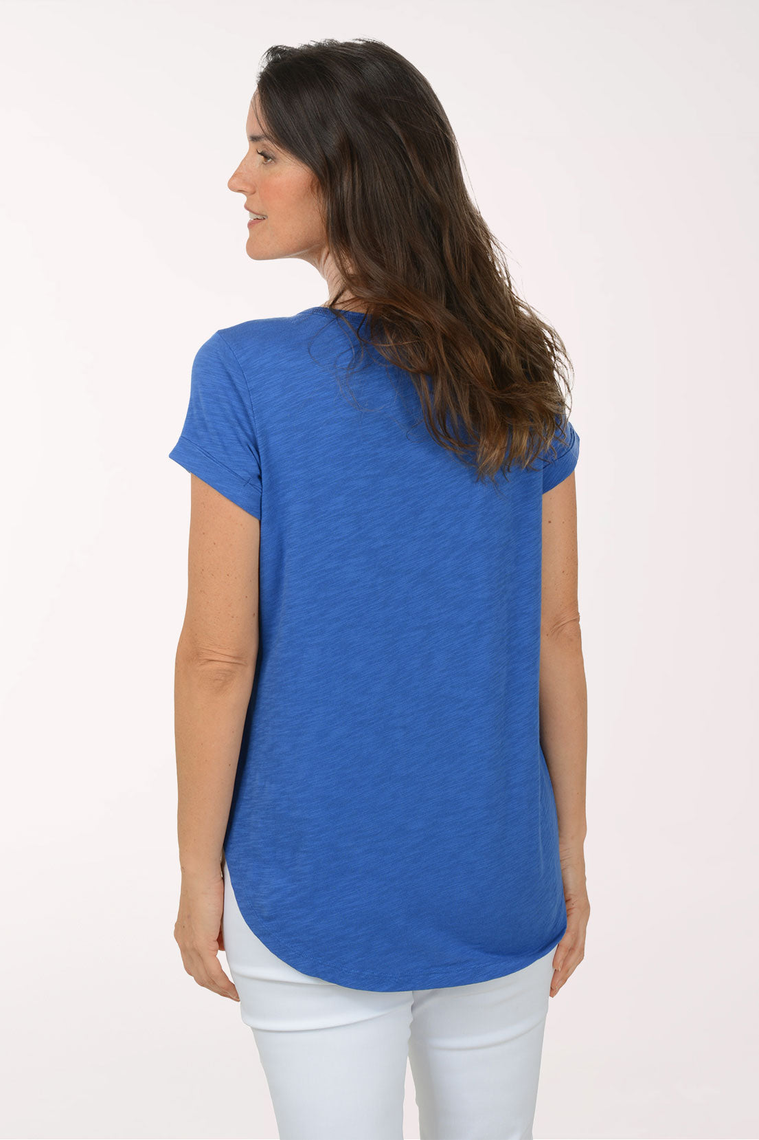 A woman wearing a short sleeve blue top.