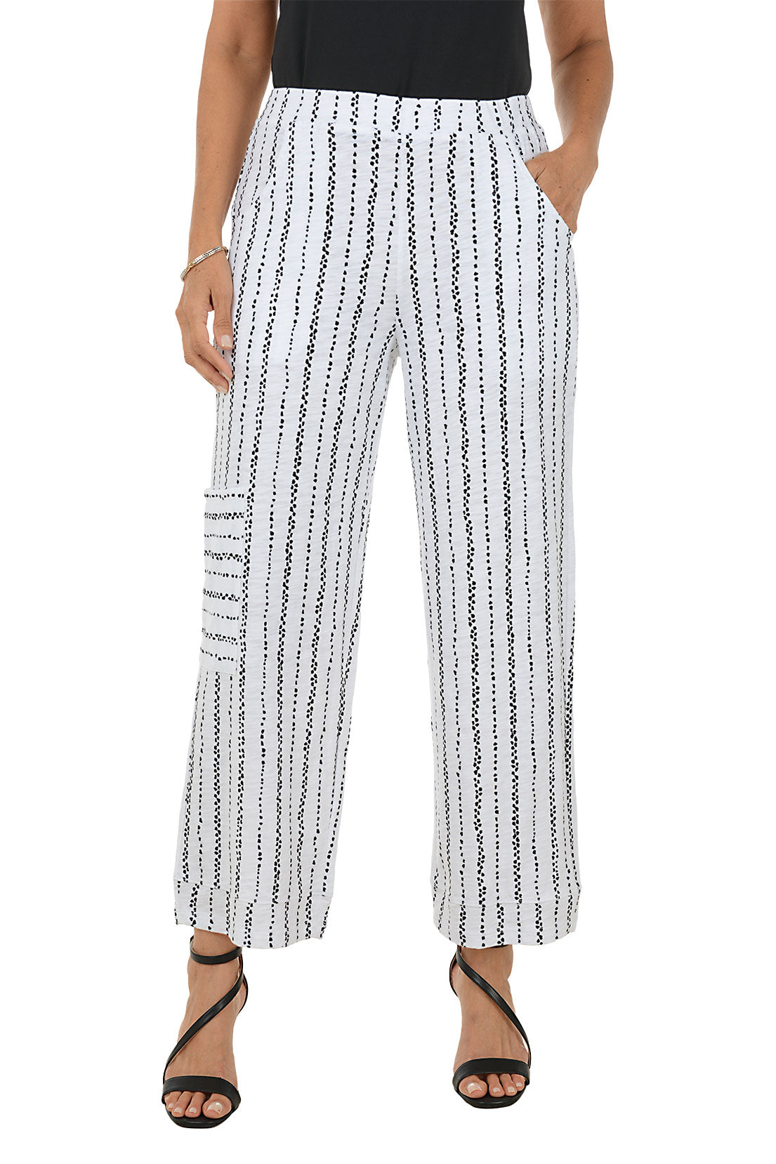 Woman wearing black and white striped ankle pants.